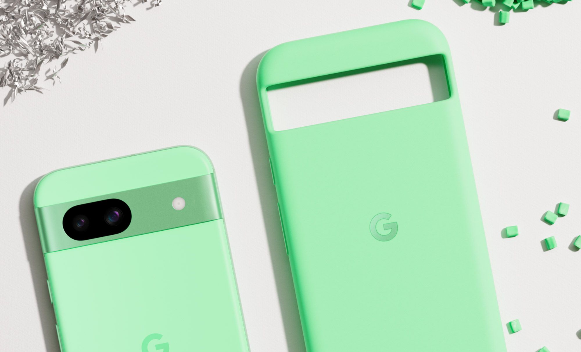 A green Pixel 8a next to a green Pixel 8a case.