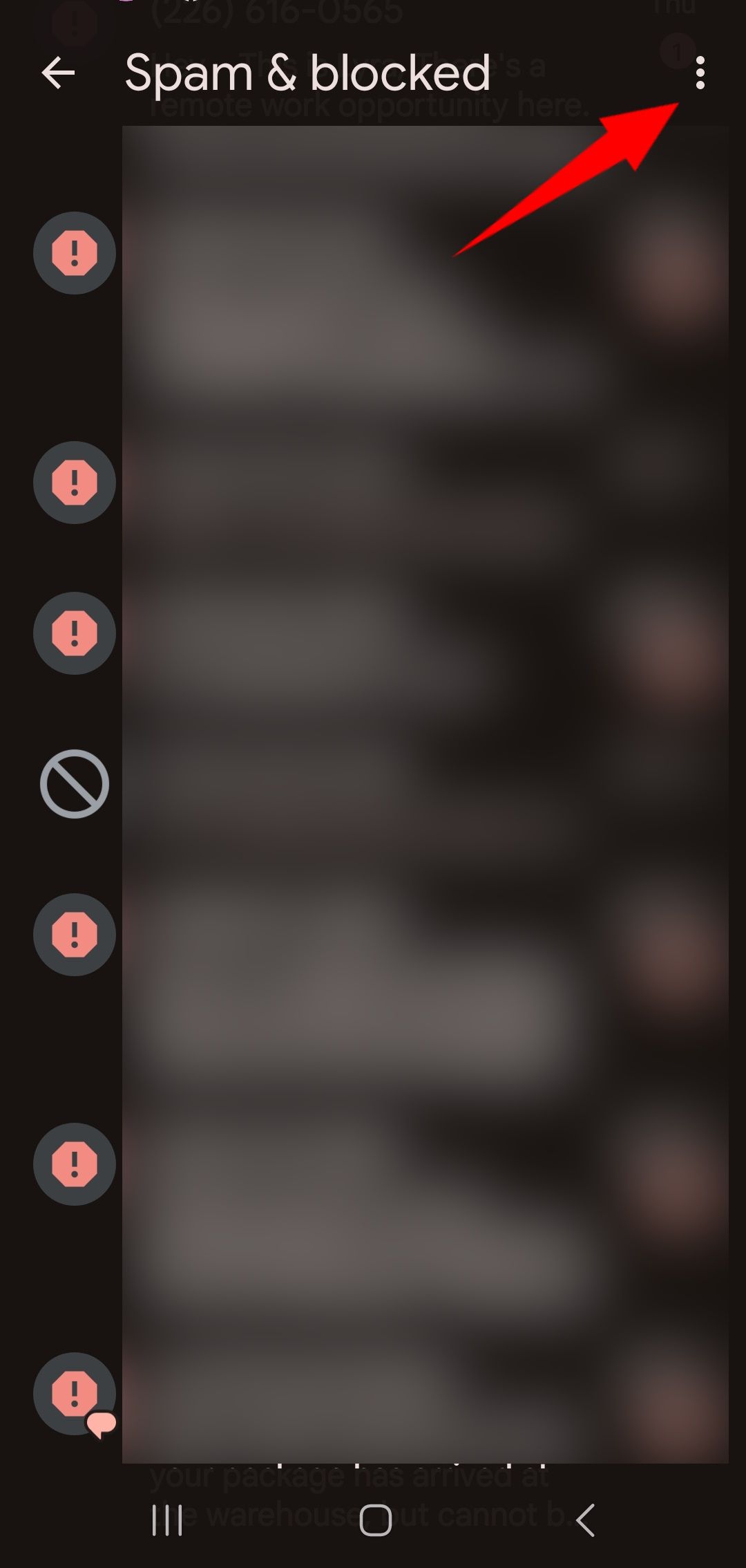 red solid arrow pointing top right to three dot menu for more options in spam & blocked