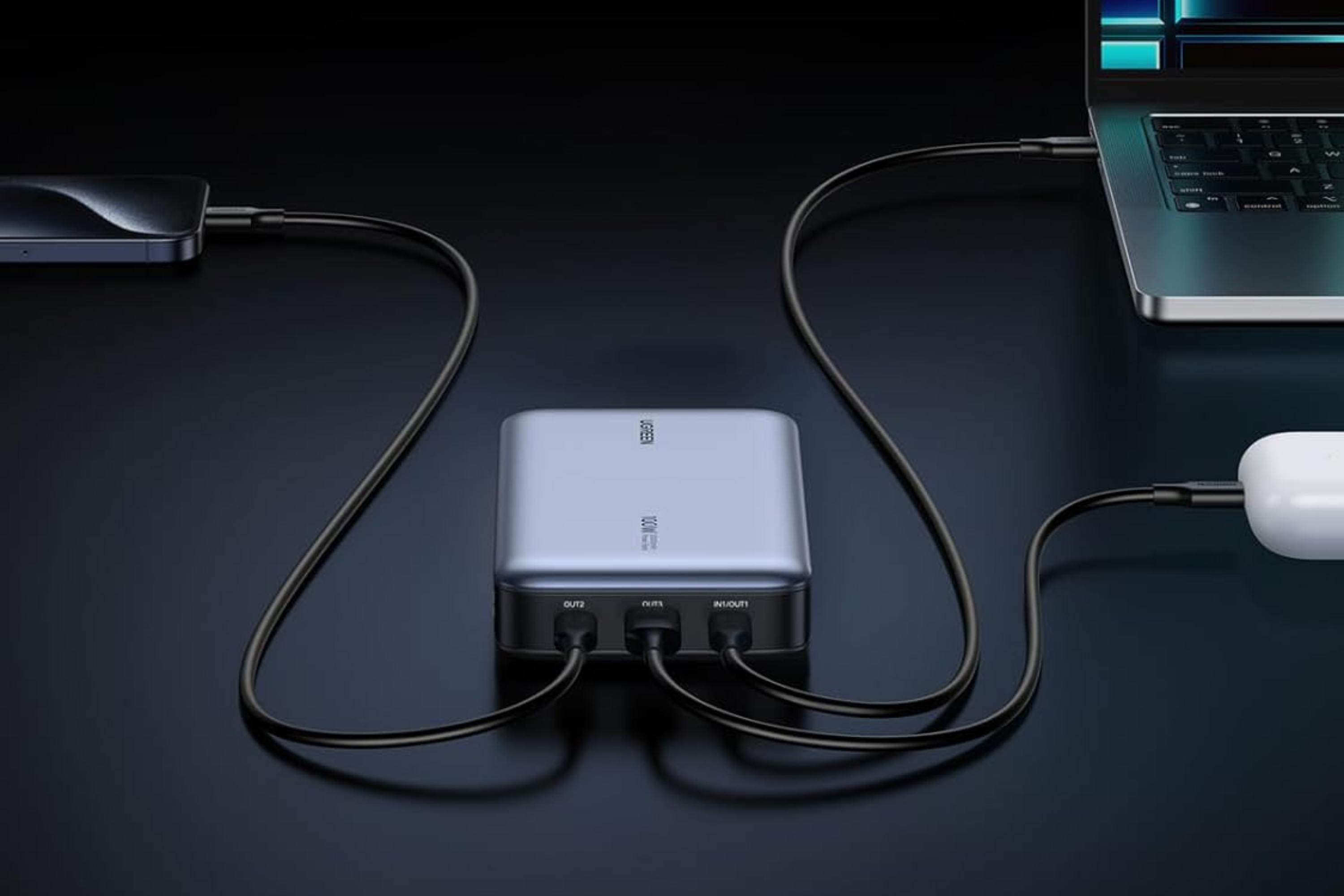 UGREEN 100W 20,000mAh Power Bank connected to laptop, earbuds, and phone