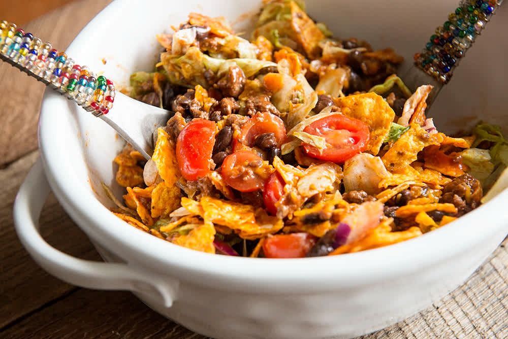 close up of a taco salad in a bowl mixed