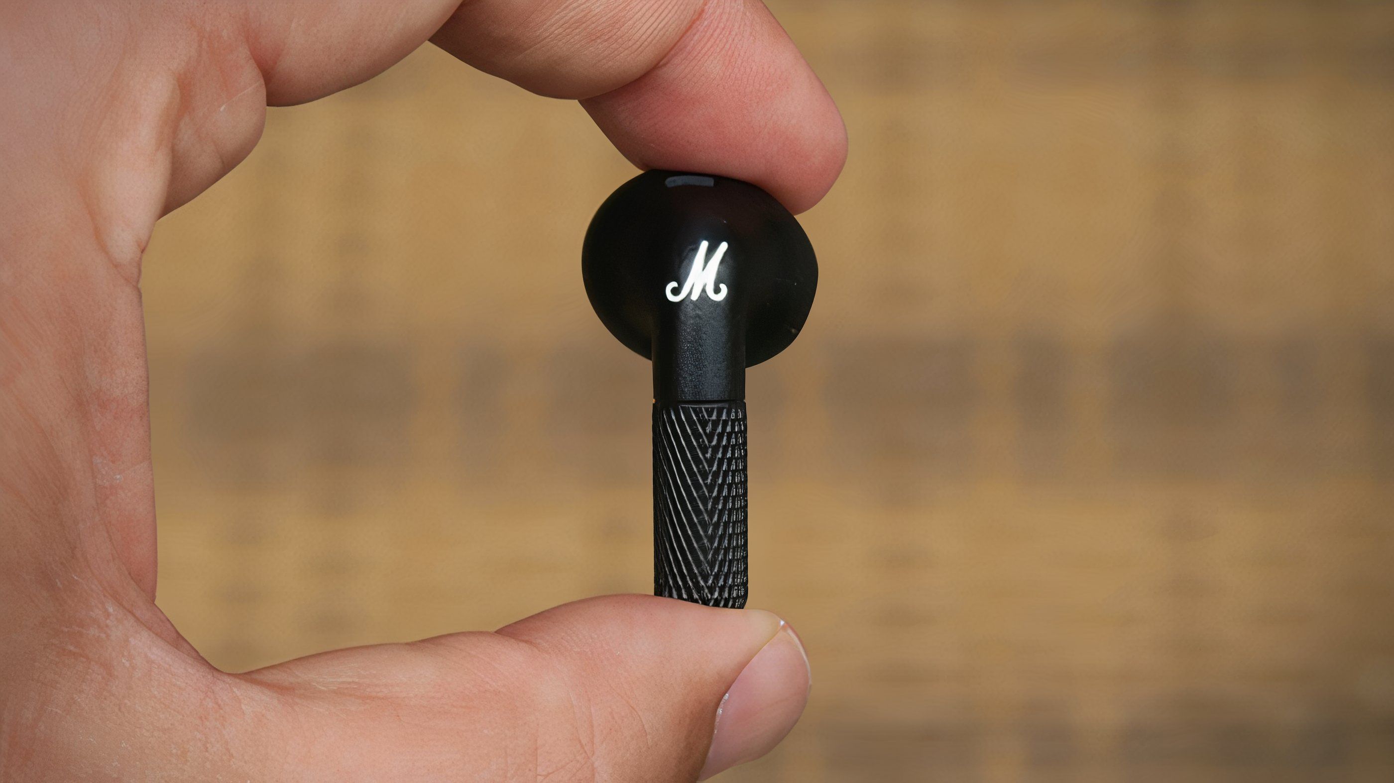 Marshall Minor IV earbud between finger and thumb