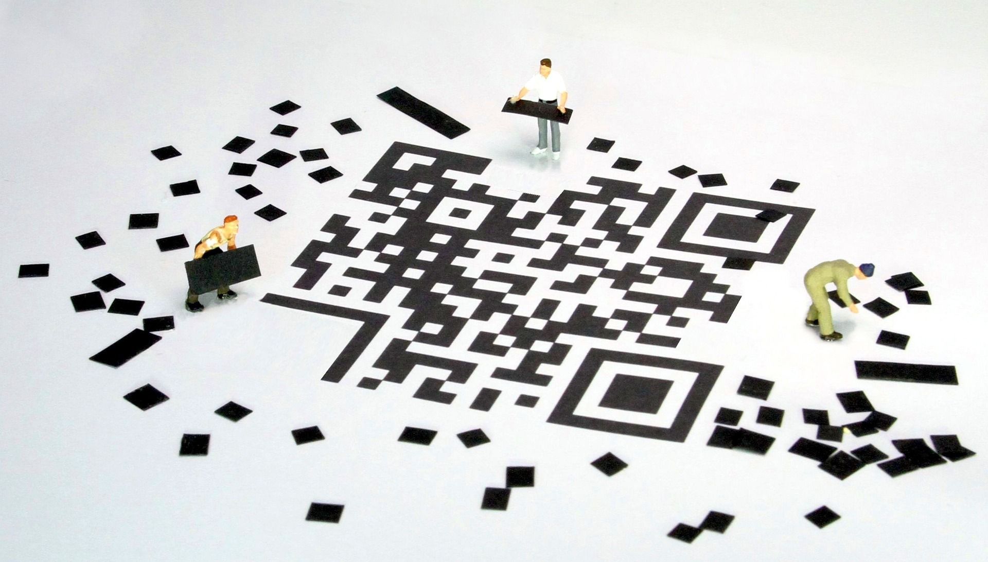 three people putting a QR code together