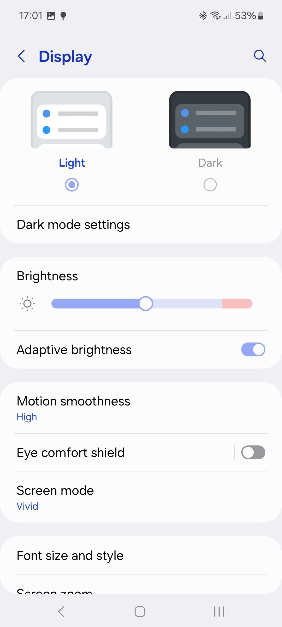 samsung display settings page with light and dark mode and brightness slider