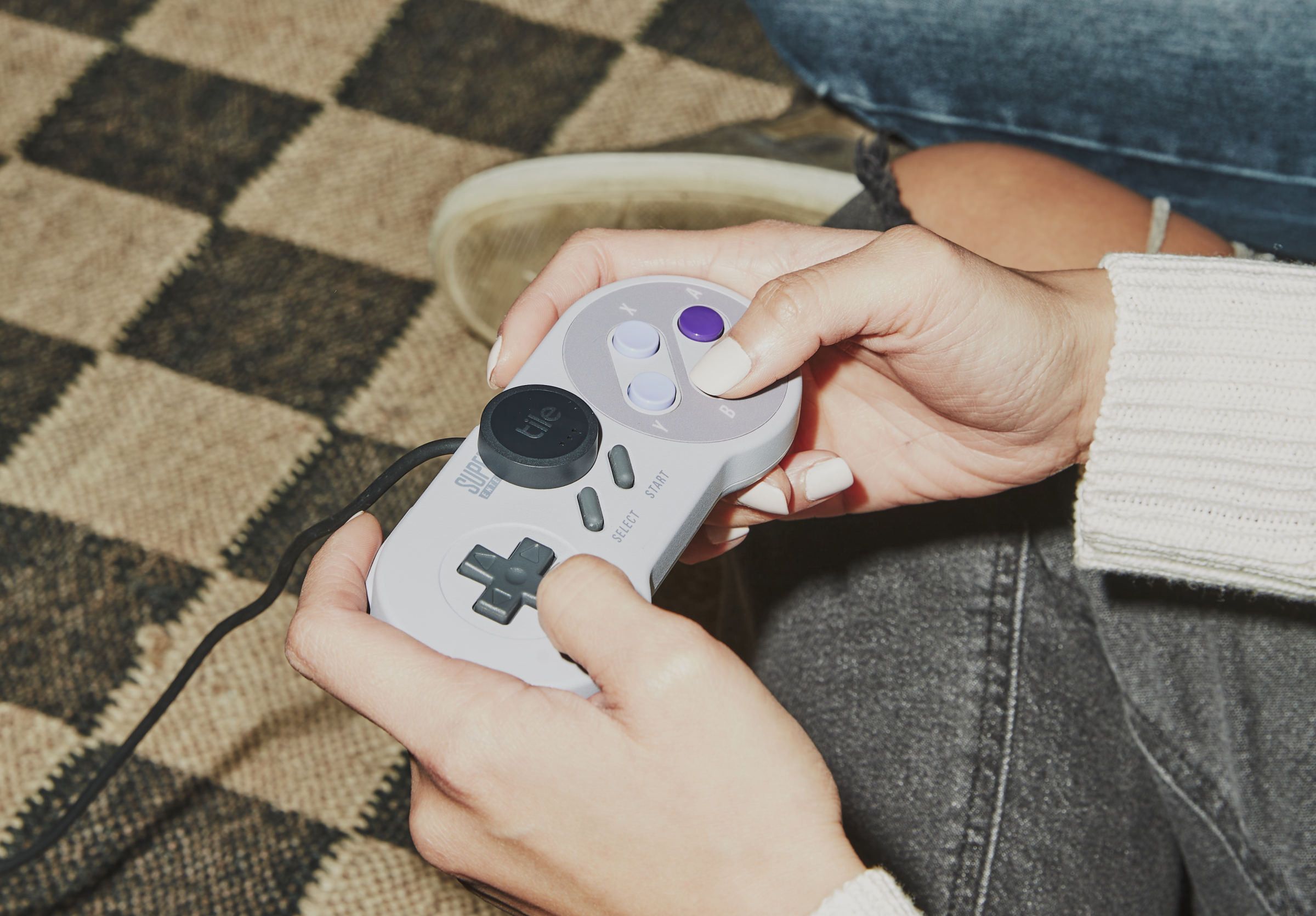 The Tile Sticker affixed to a Super Nintendo gamepad