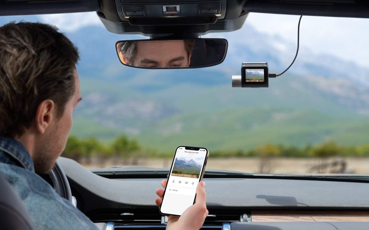 Man Looking at Phone Connected to 70mai A510 in Car