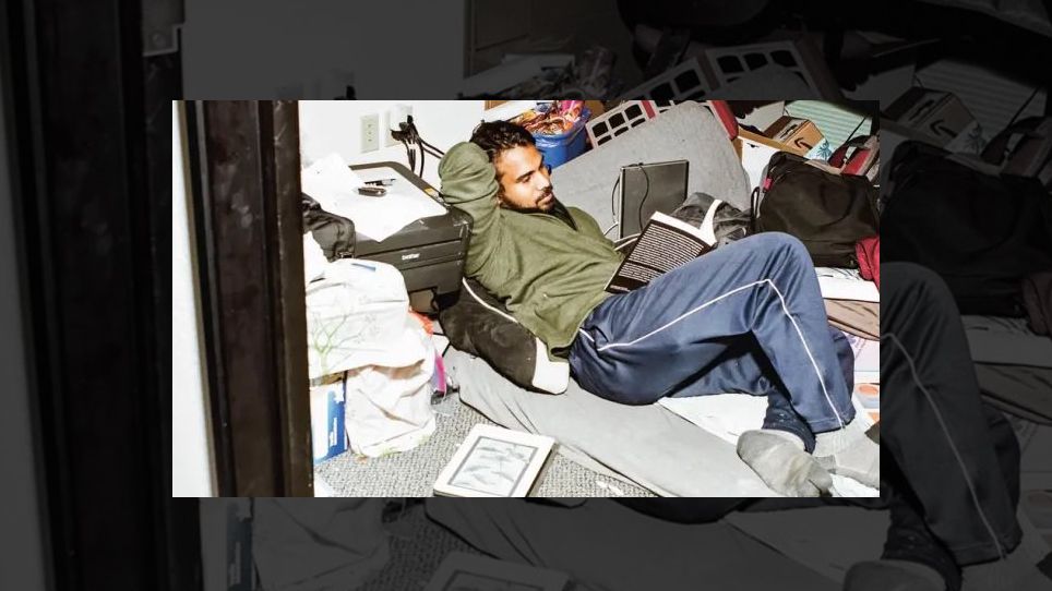 Anjan Katta reading in a cluttered office