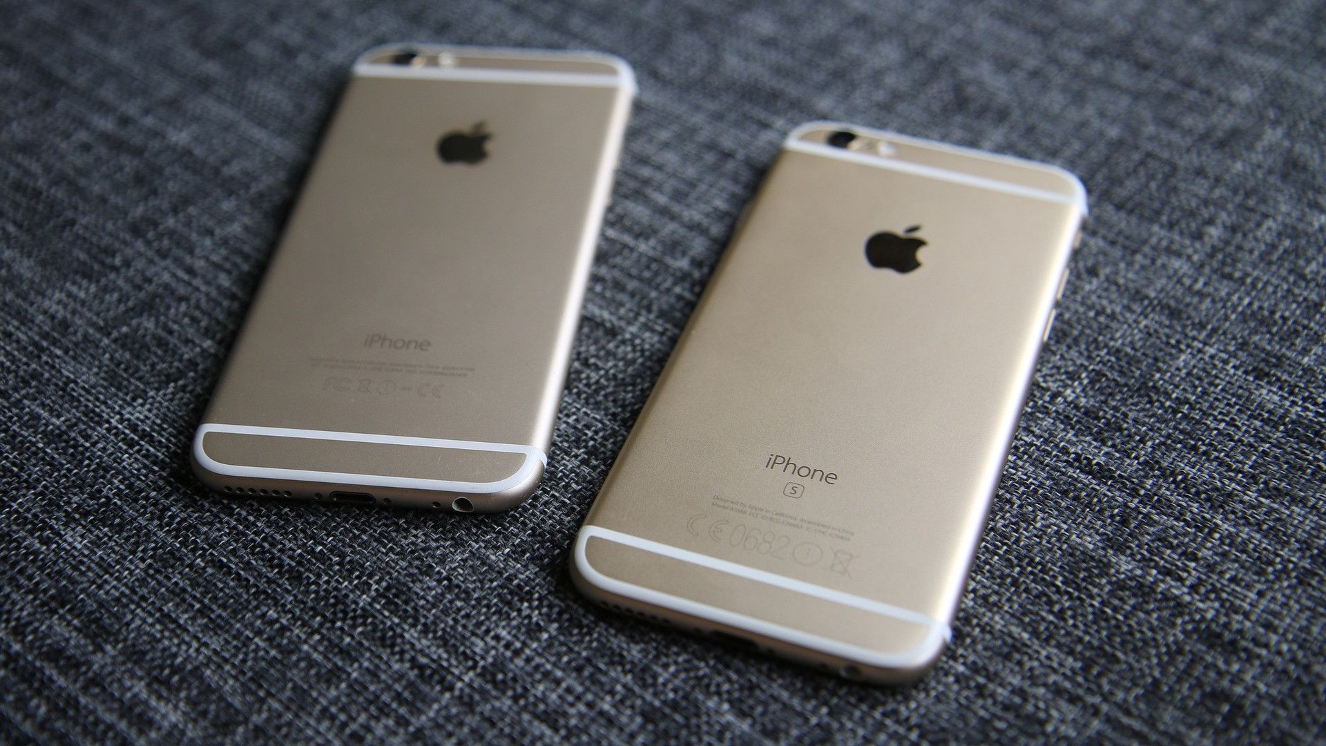 apple iphone 6 and 6s phones gold color face down on fabric surface