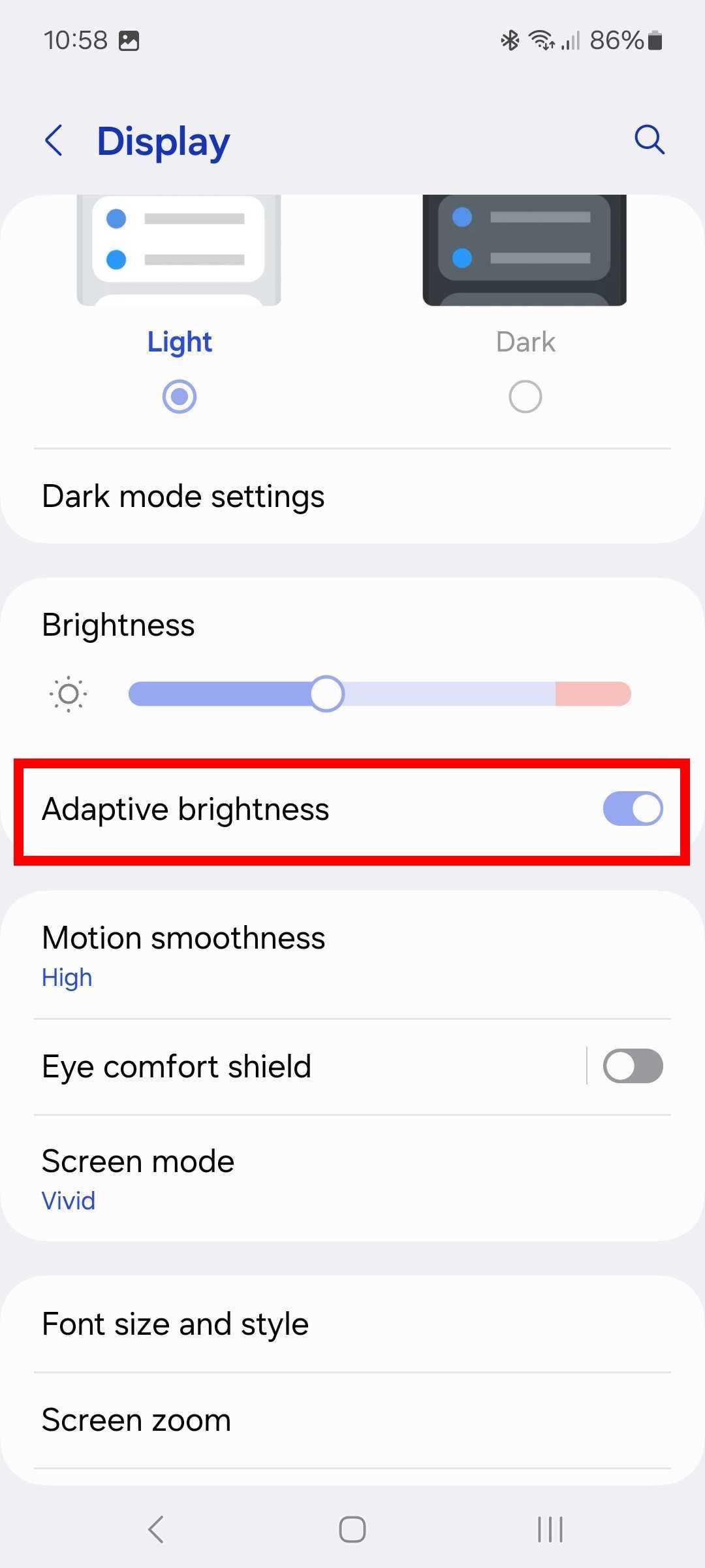 Red rectangle outline highlighting Adaptive brightness toggle in Display settings