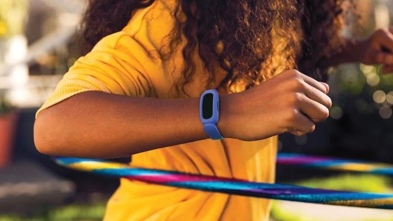 Fitbit Ace 3 kid with hulu hoop wearing a yellow shirt