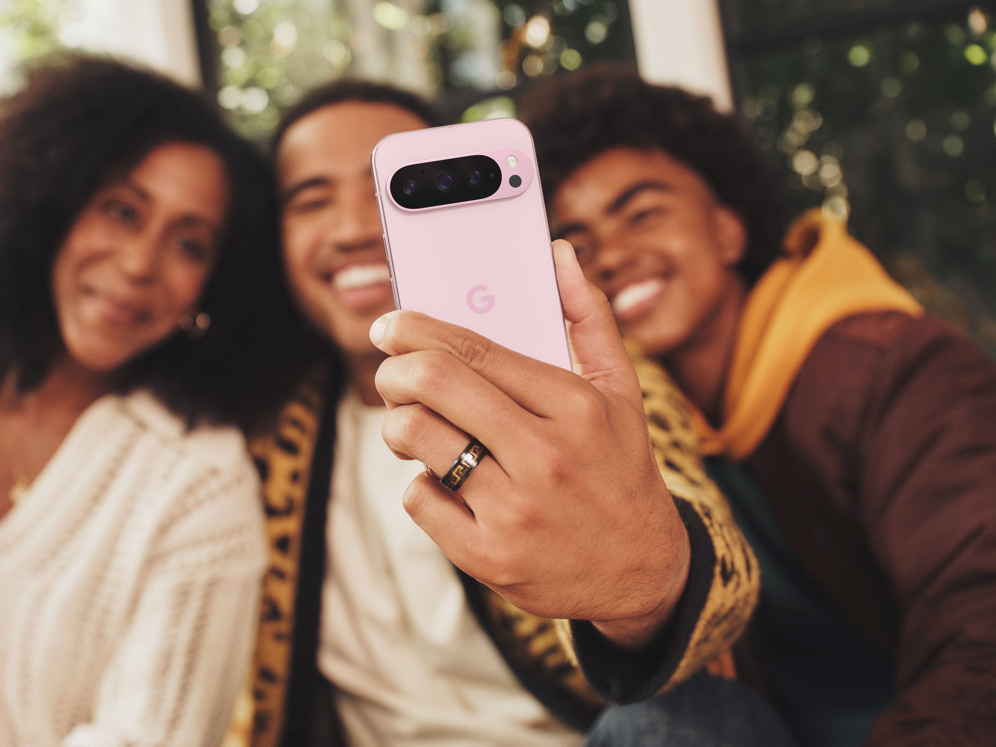 Group of people using the Pixel 9 Pro to take a selfie.