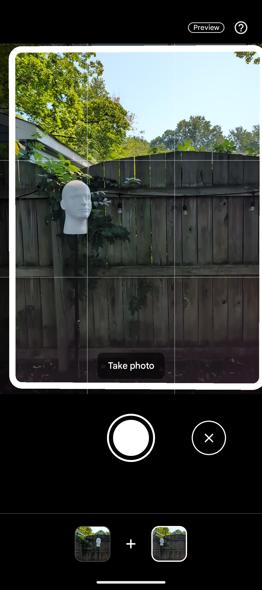 pixel 9 camera viewfinder showing mannequin head in front of garden fence