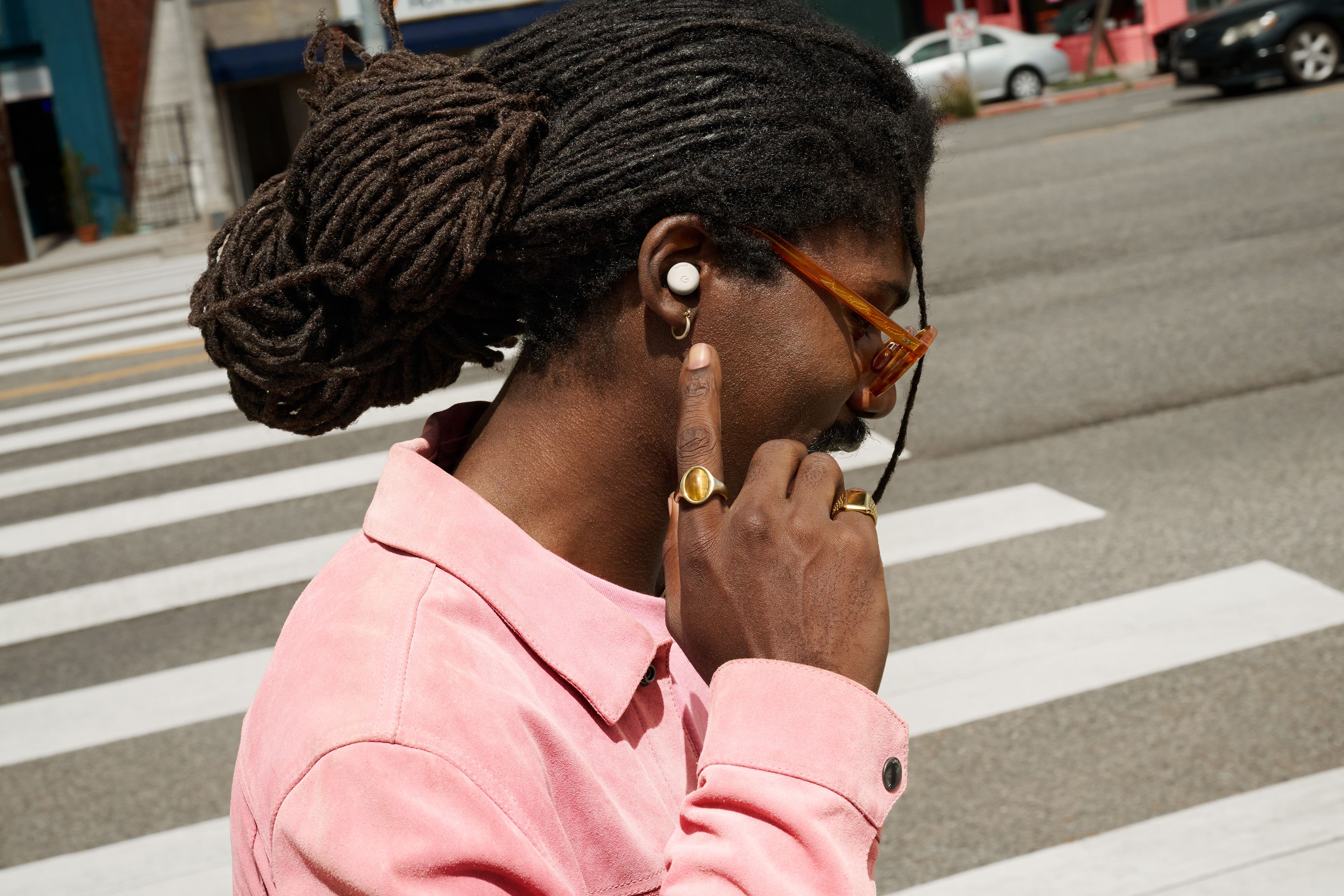 A person wearing the Pixel Buds Pro 2 while walking on a street.