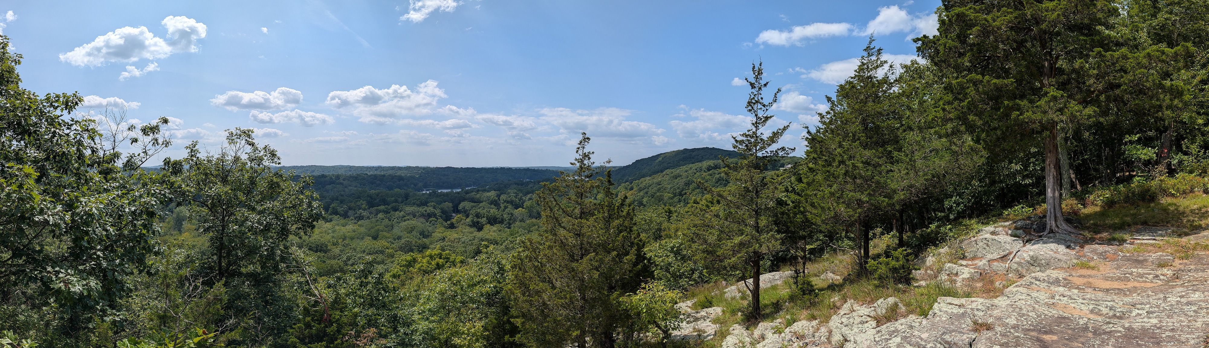 A panoramic shot of a park overlooking a valley.