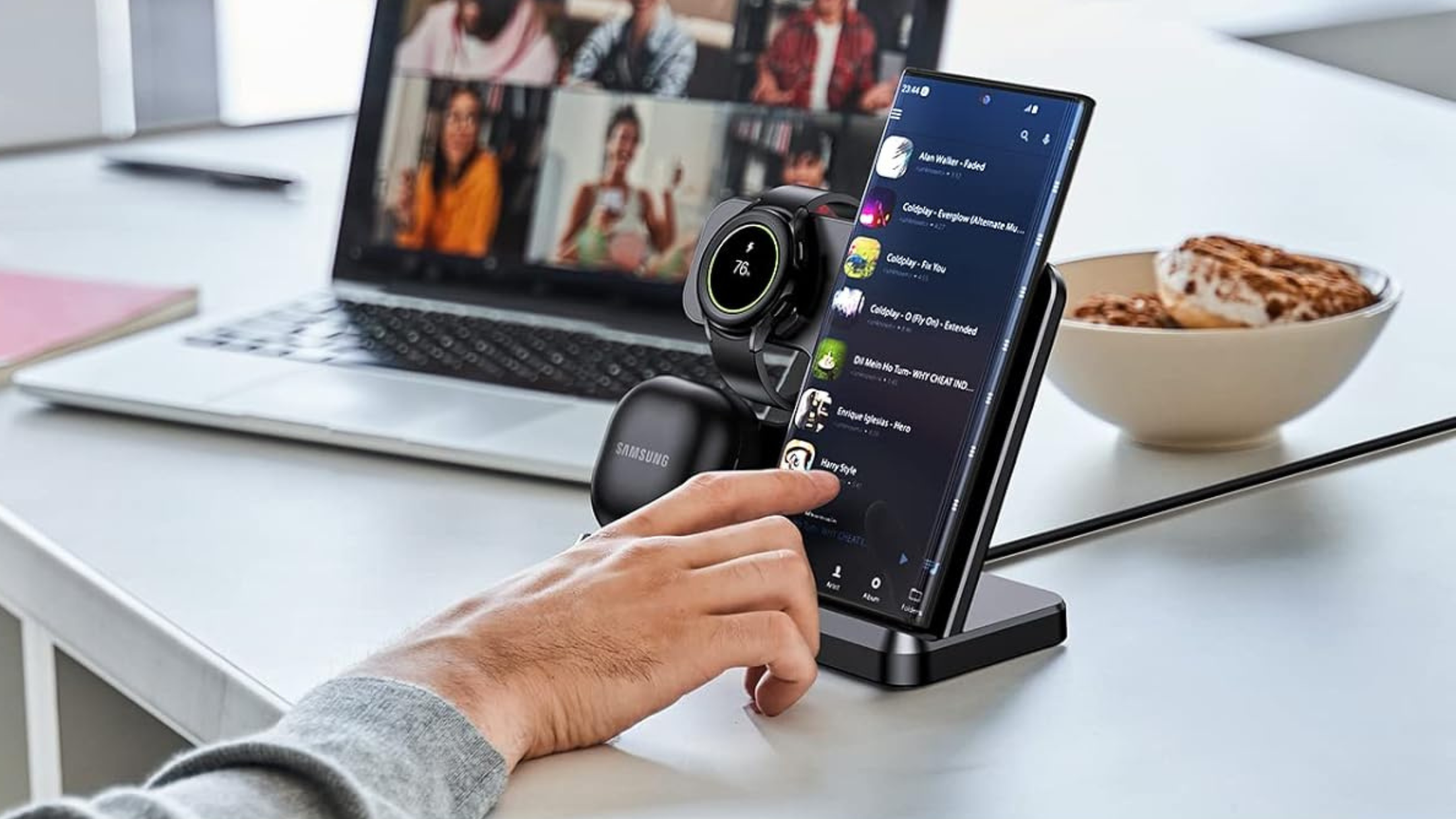 person charging Samsung phone earbuds and watch on ZUBARR Wireless Charger for Samsung