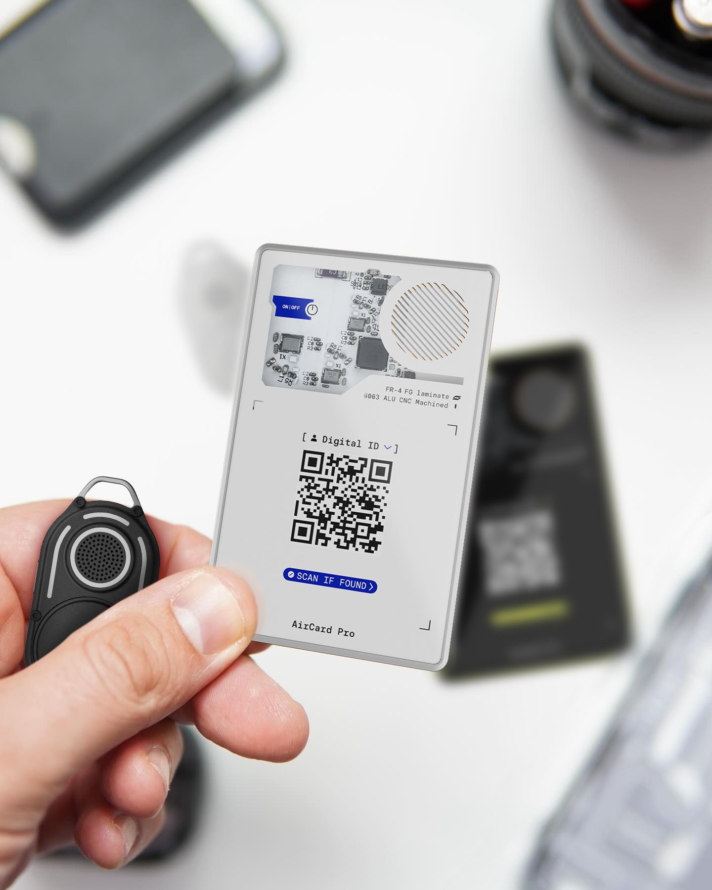 A person holding the AirCard Pro Bluetooth tracker by its corner