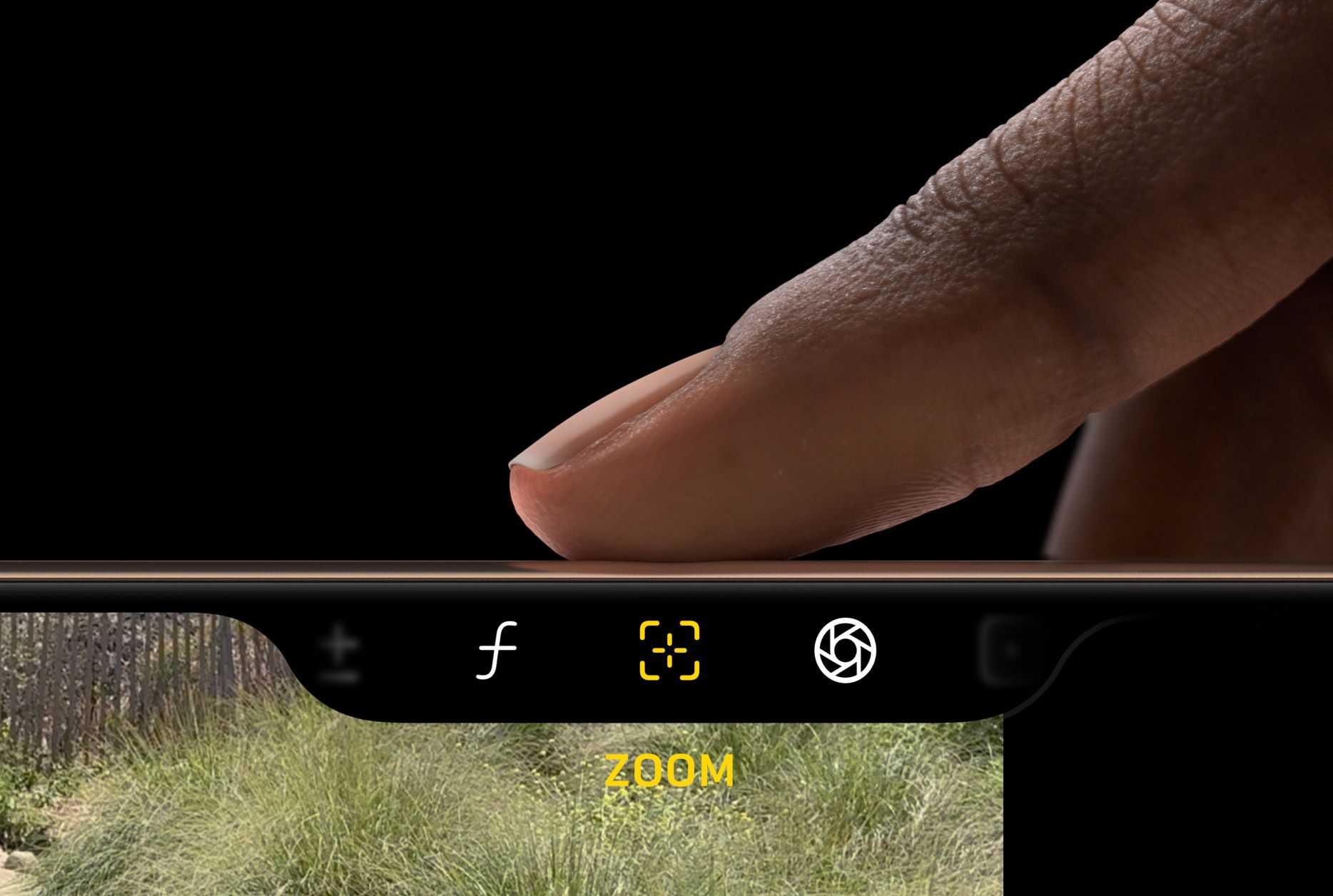 A finger pressing the camera control button on an iPhone 16 Pro.