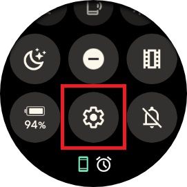 The swipe down menu on a Google Pixel watch with a red box around the settings gear icon