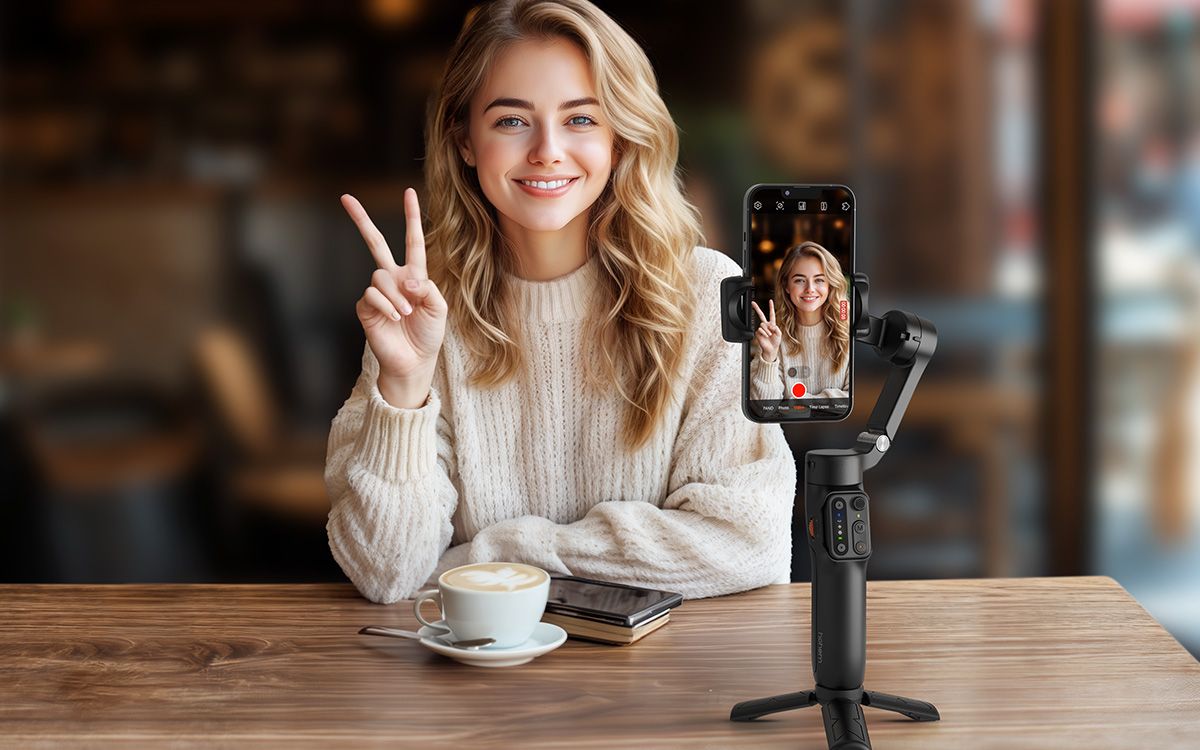 Woman using Hohem iSteady X3 SE to photograph herself while drinking coffee