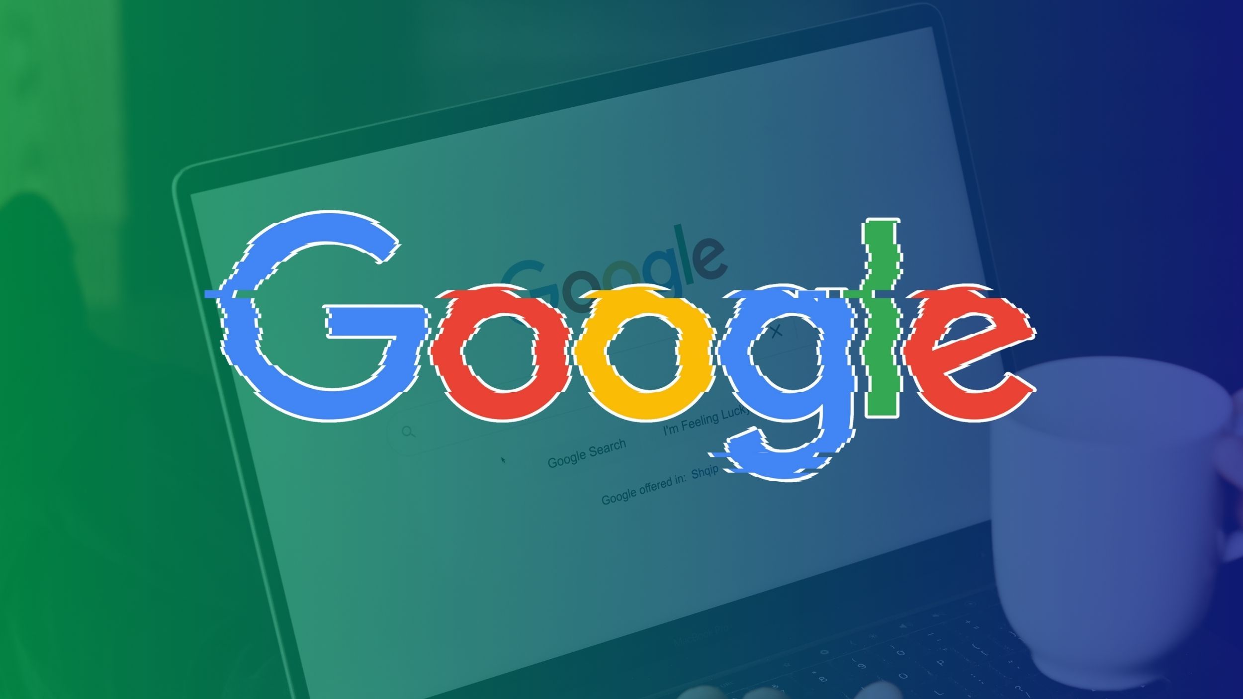 Shaking Google logo with Google Search home page open on a laptop alongside a white mug in the green and blue gradient background