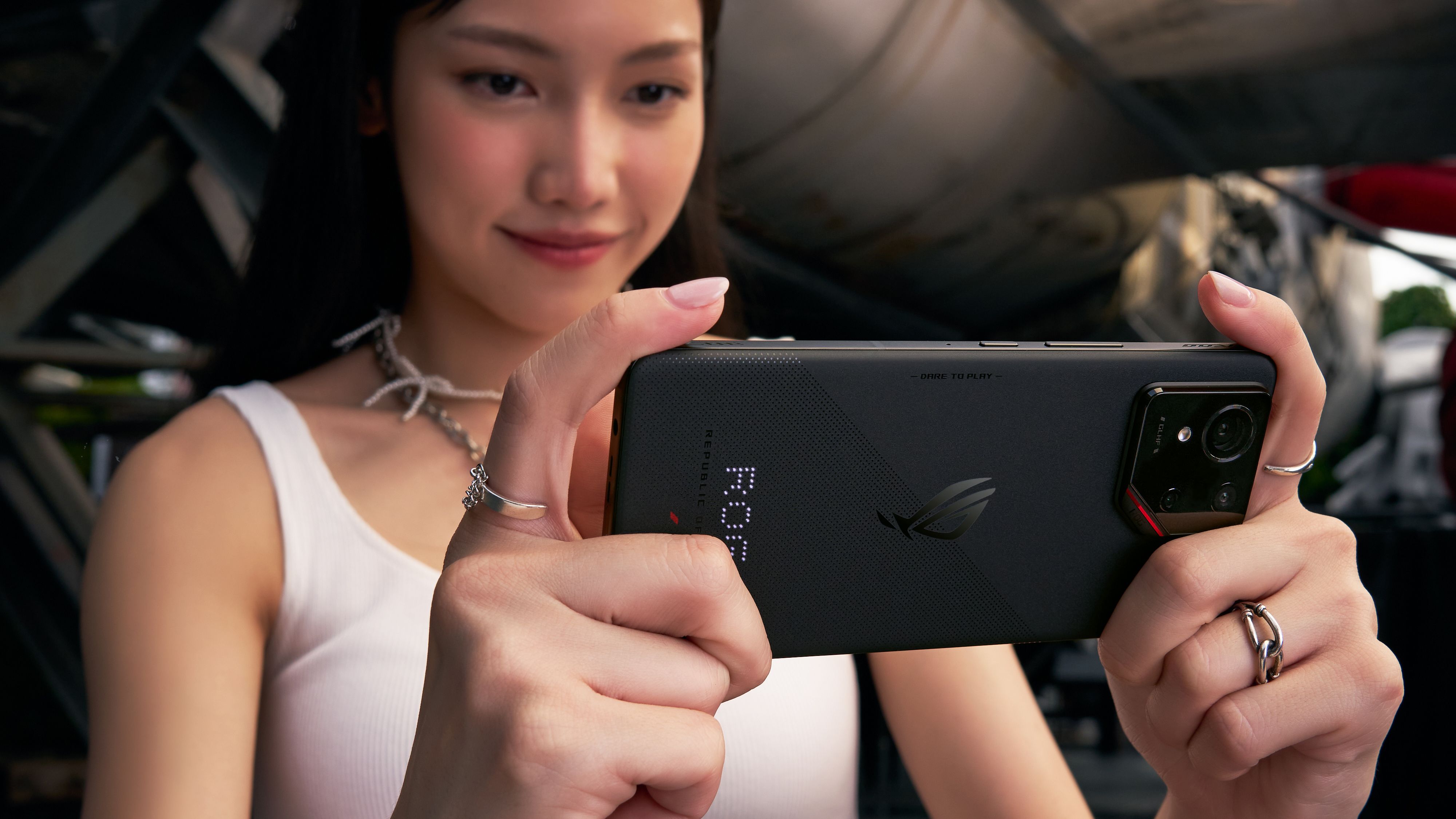 Woman taking a photo with the ROG Phone 9