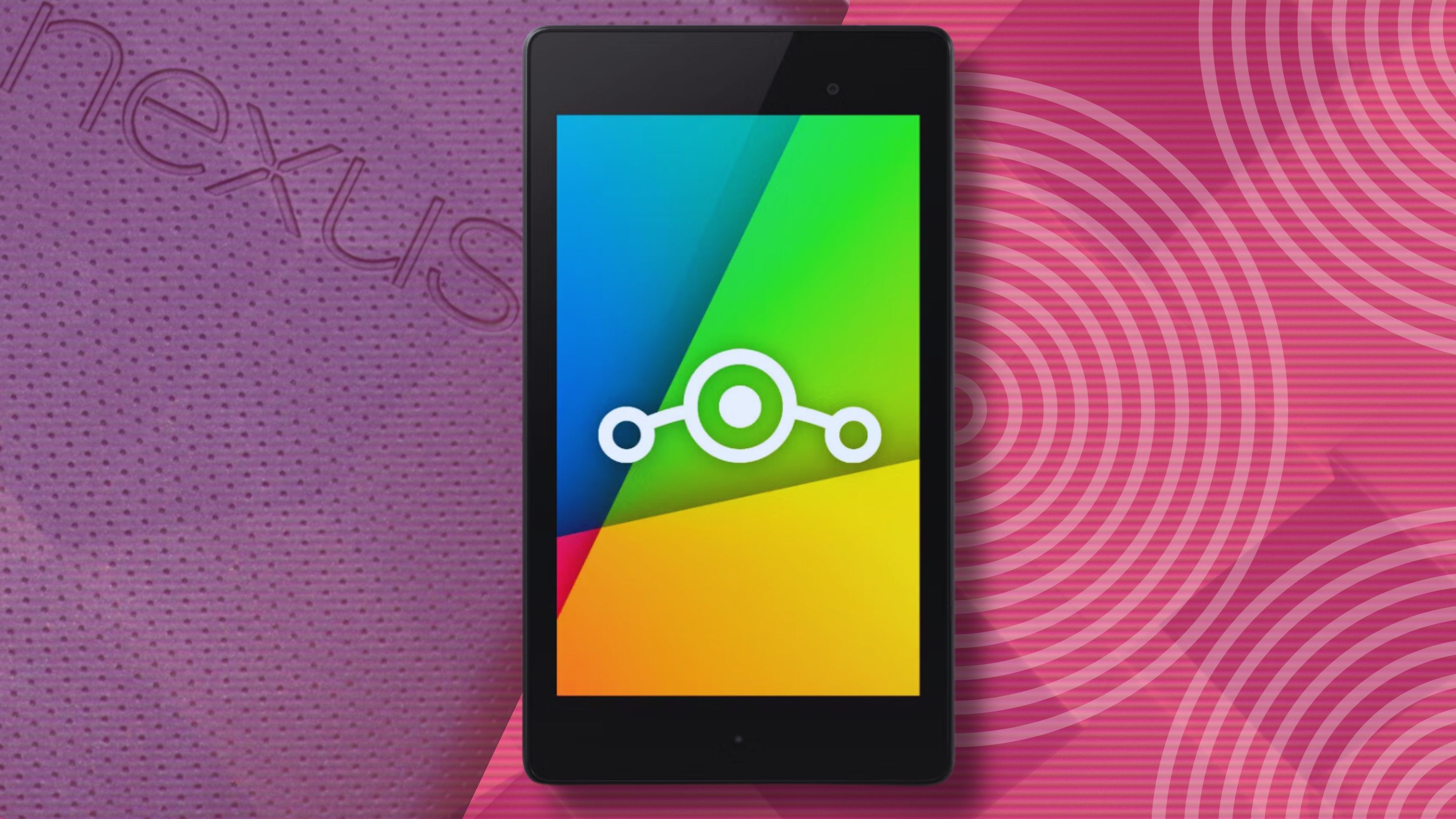 A Google Nexus 7 tablet over a colorful backdrop.