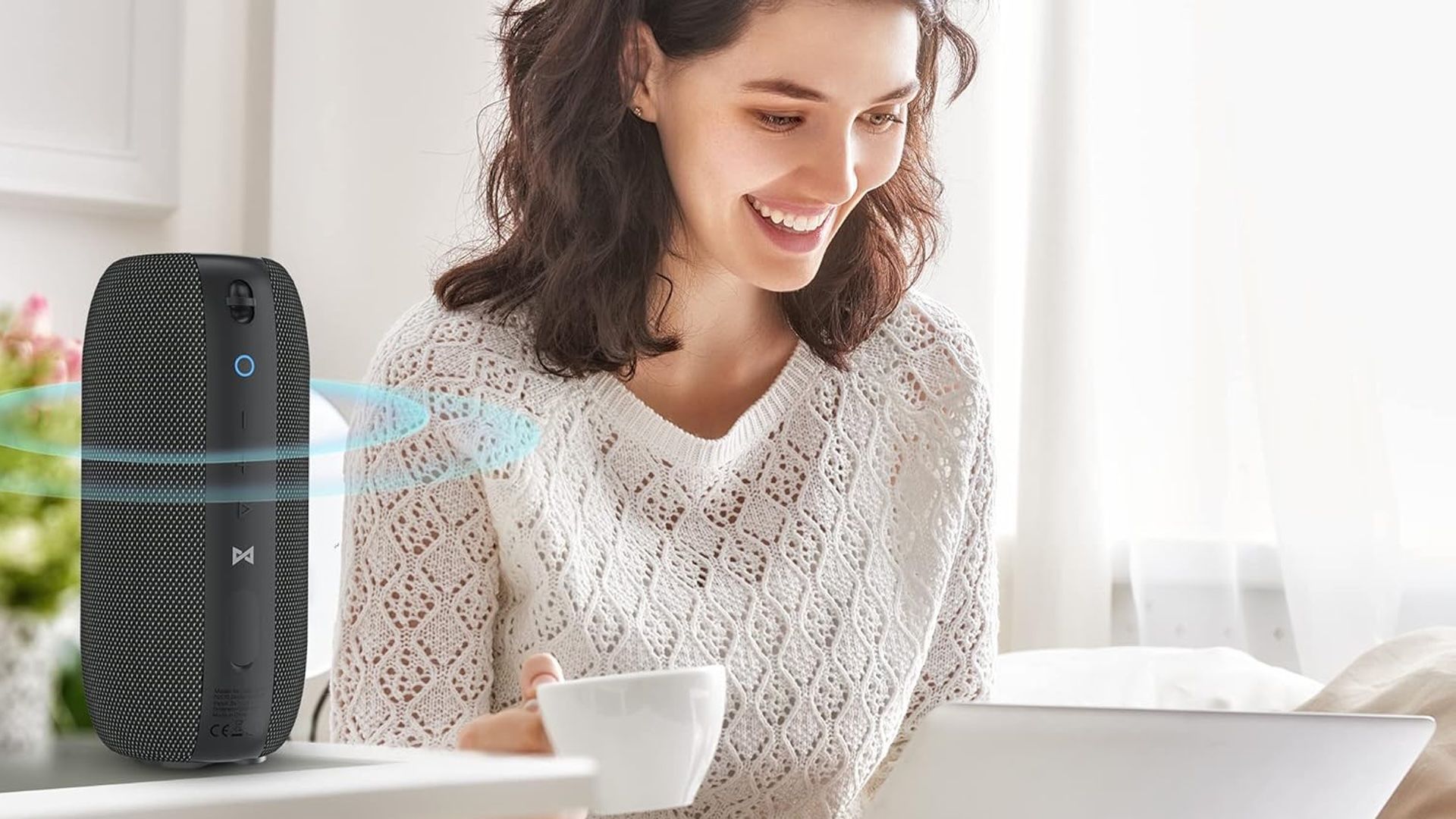 A woman listens to the Monster S320 while using her laptop.