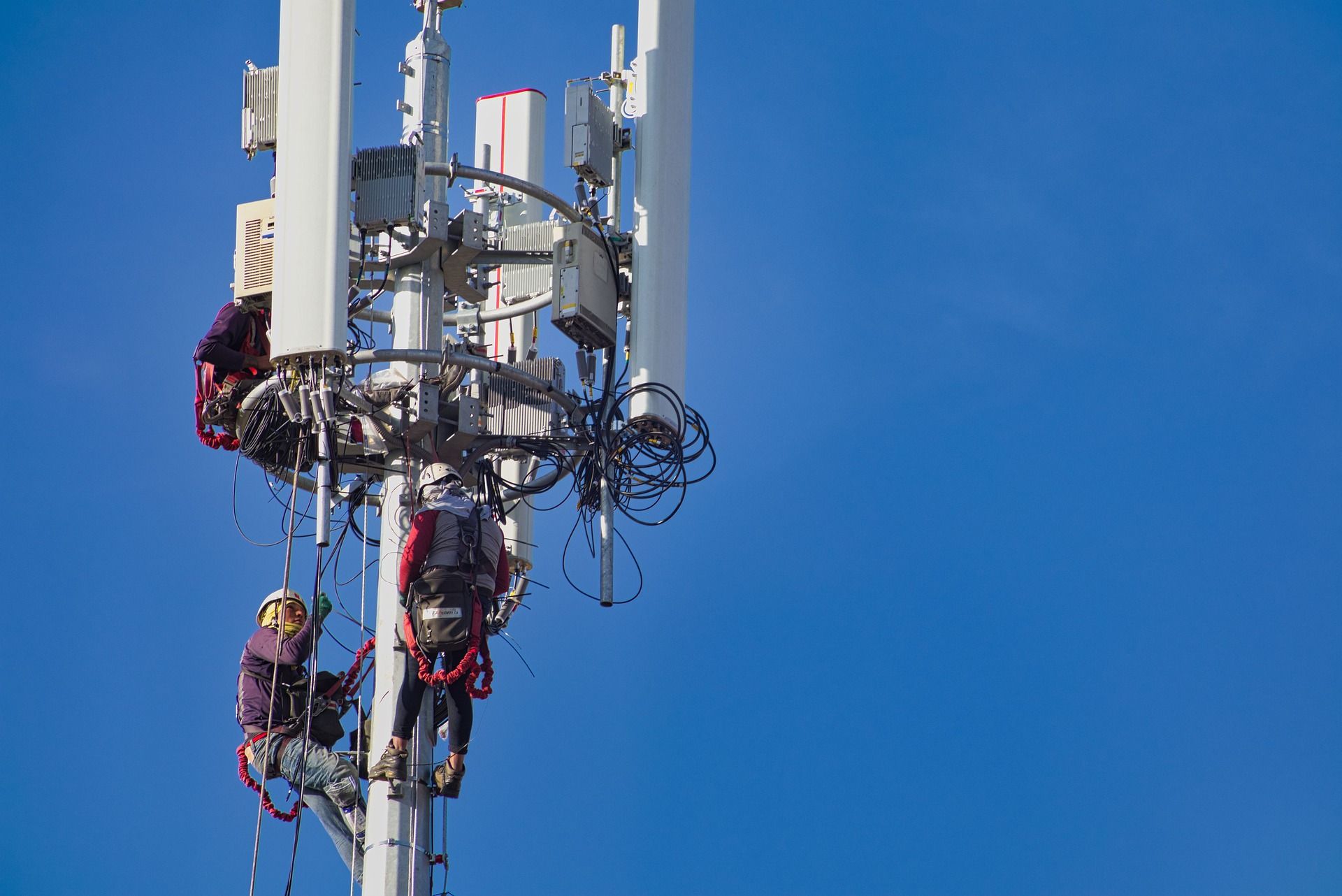 A cellphone tower against a blue sky.