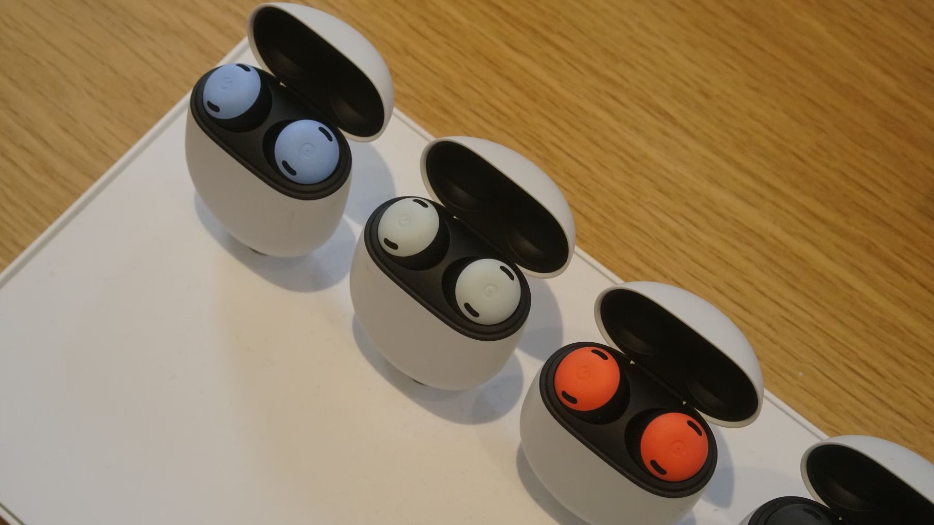 A row of Google Pixel Buds Pro earbuds in different color options.