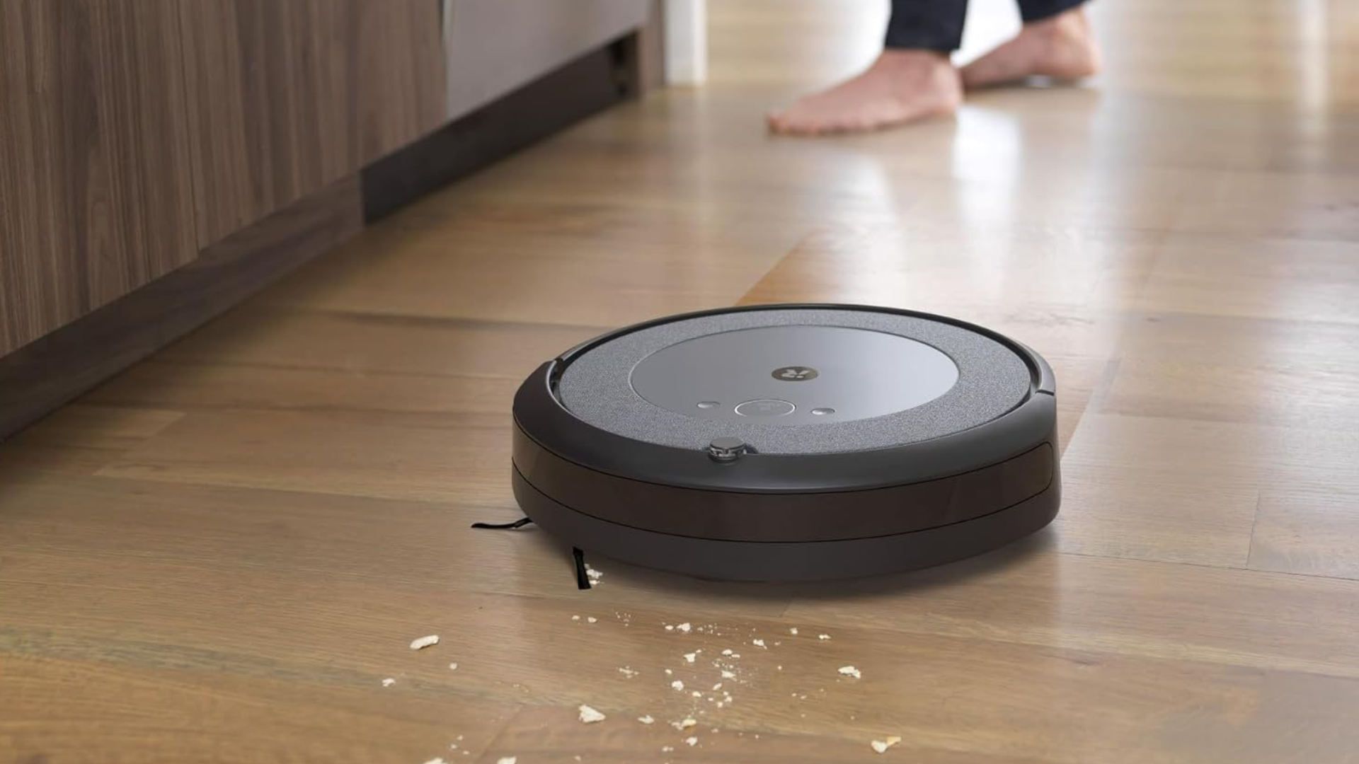 The iRobot Roomba Combo i5 picking up debris from a hardwood floor.