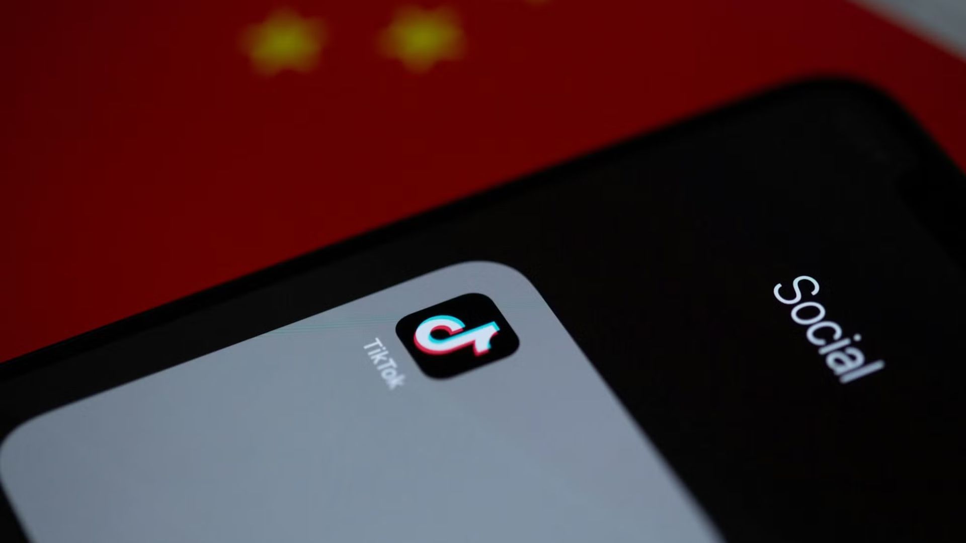 tiktok app icon over blurred red surface