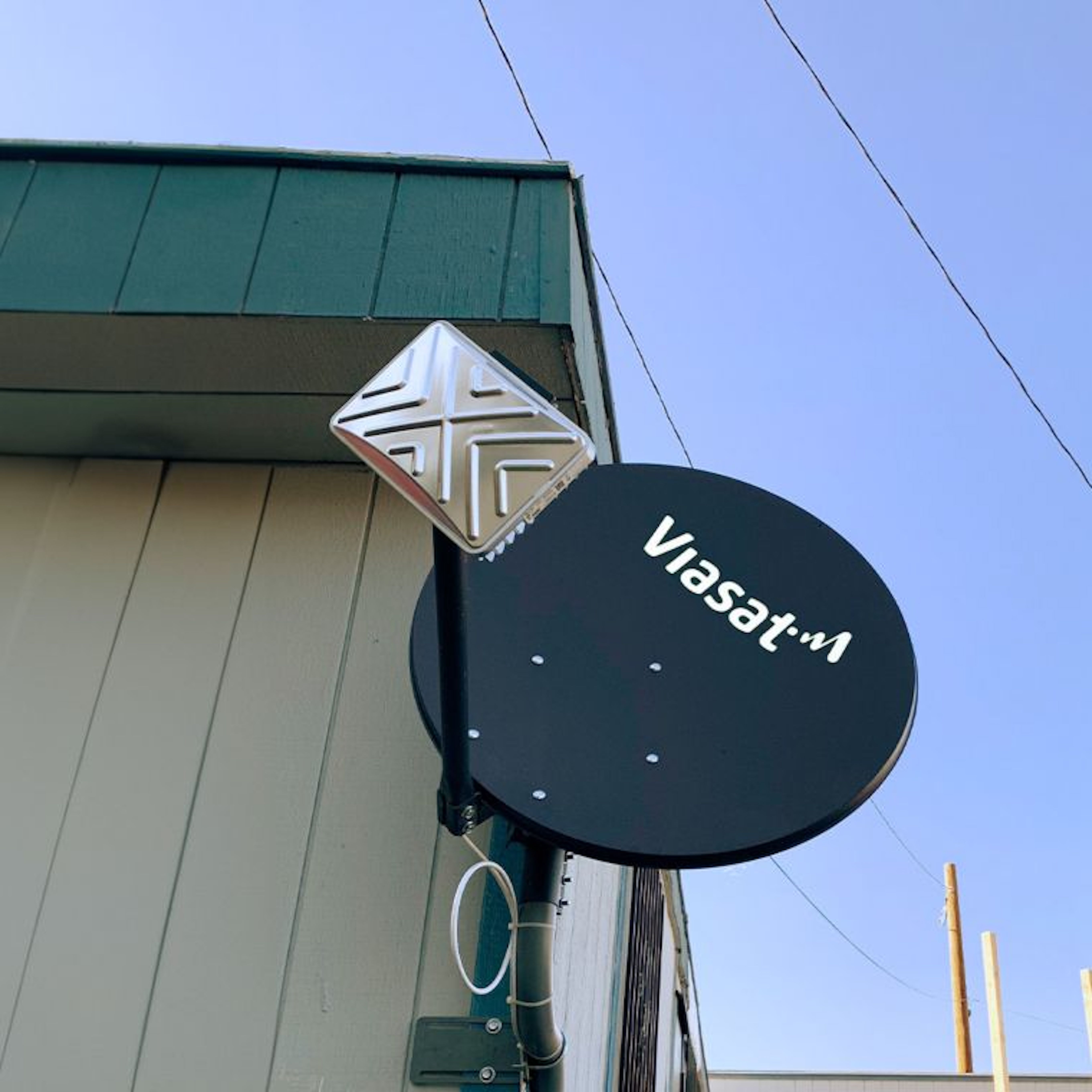 viasat satellite mounted on wall daytime