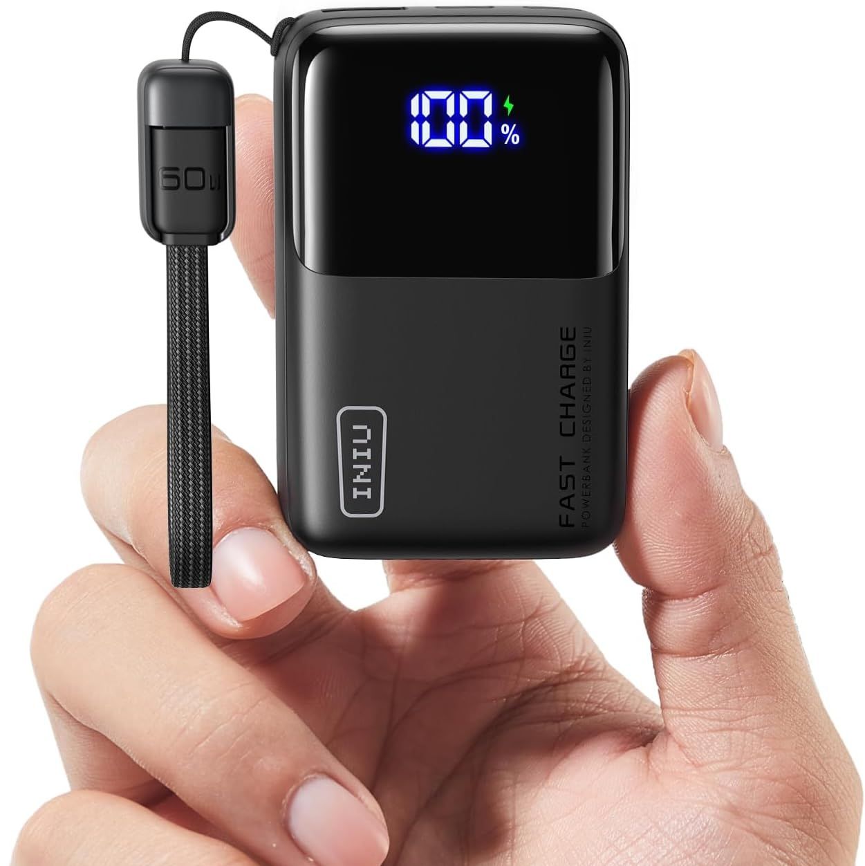 INIU portable charger in black being held by a hand against a white background