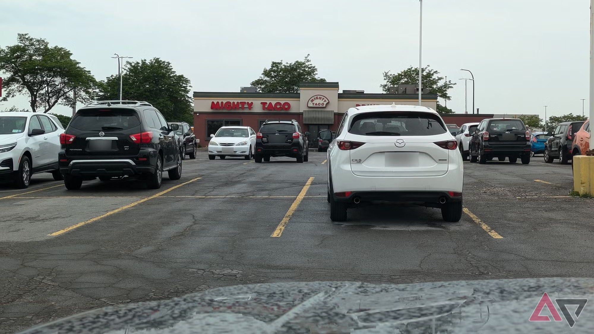 A picture of a parking lot outside a strip mall.