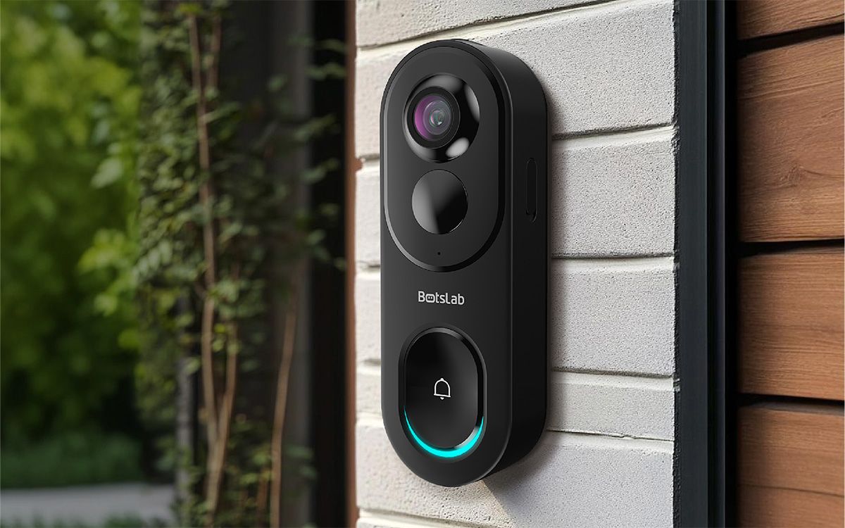 A black video doorbell against a grey house