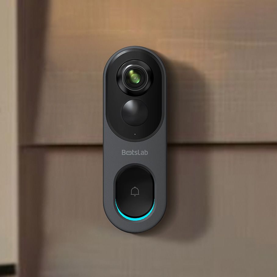 A grey video doorball against a brown house