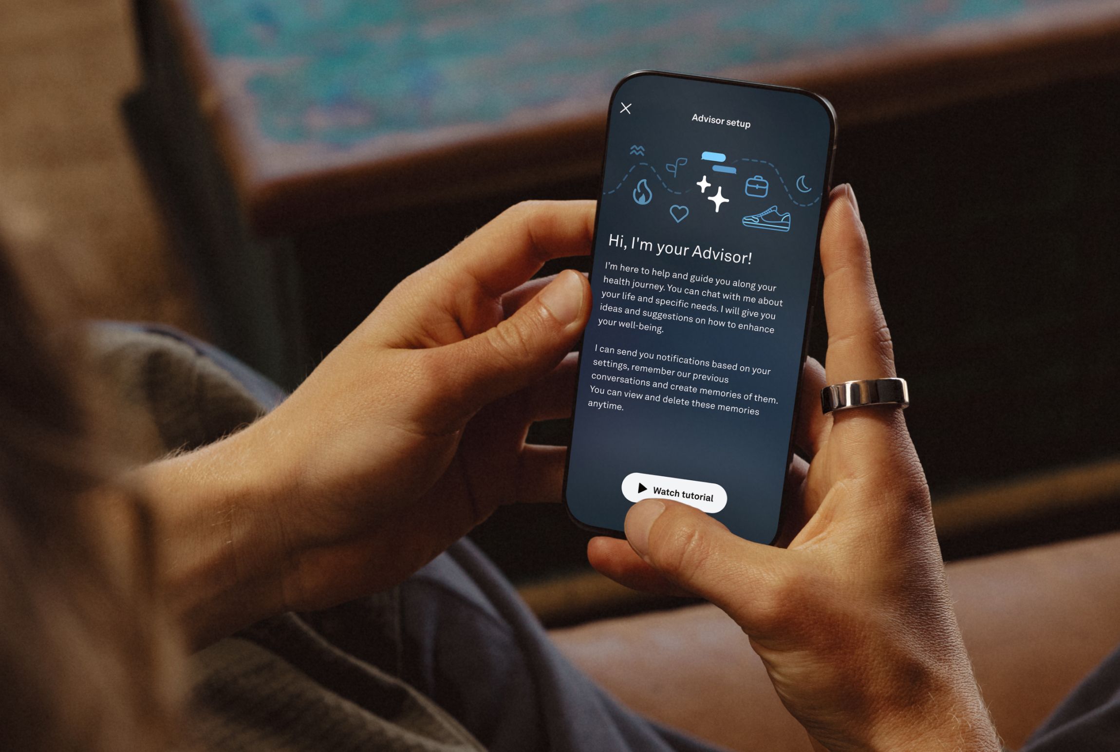 A person holding a phone with Oura Advisor open