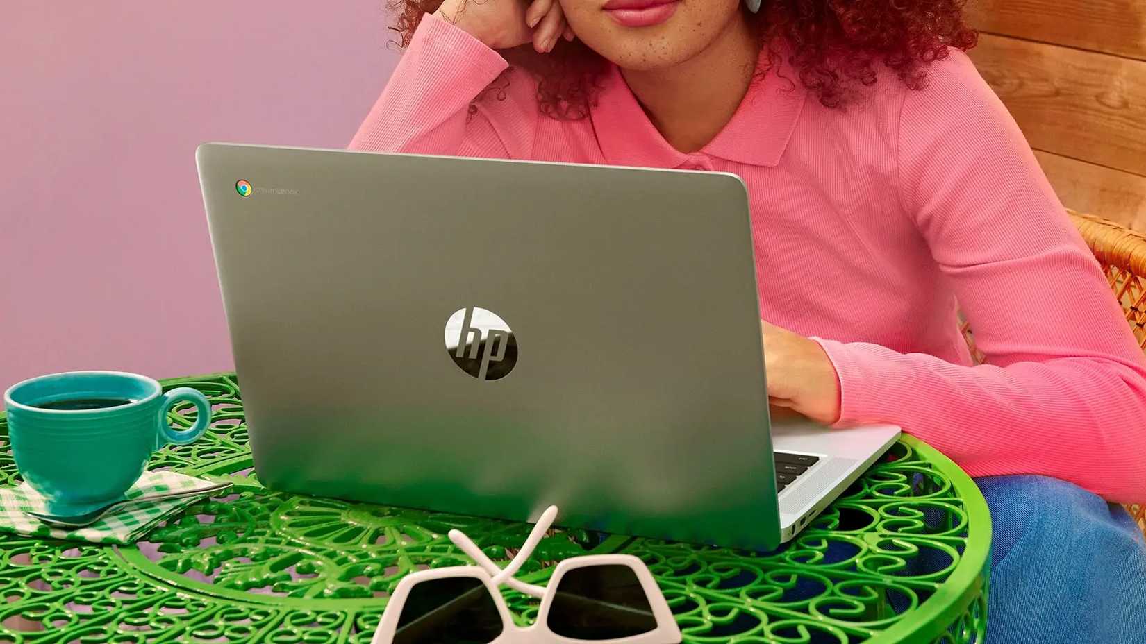 A woman works at an HP Chromebook 14a.