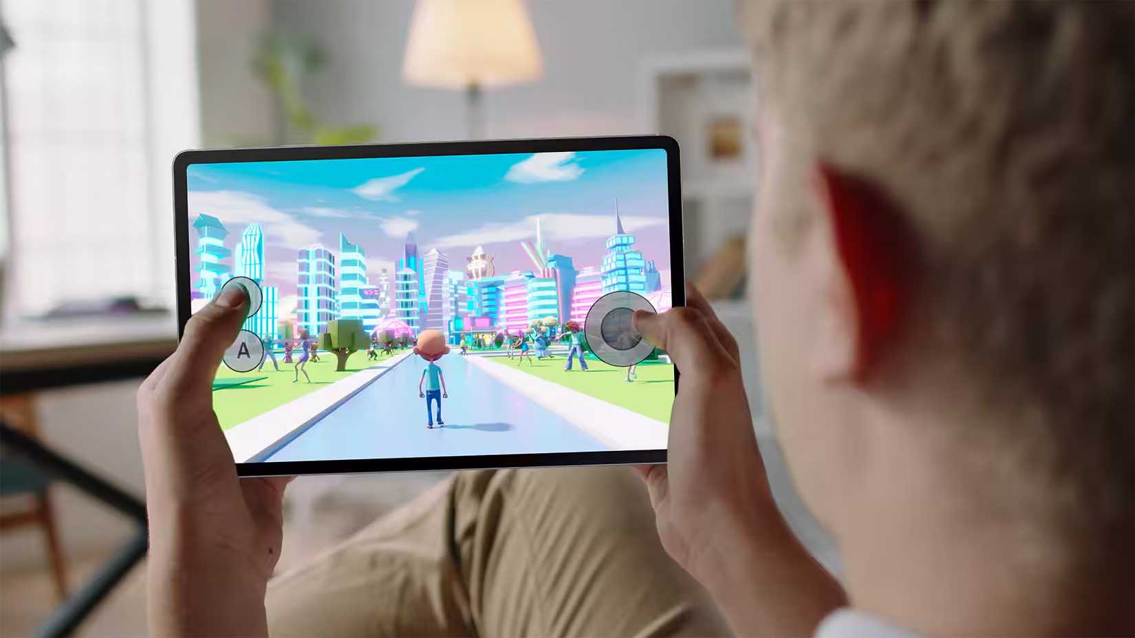 A person holding the Samsung Galaxy Tab S10 FE while playing a game.