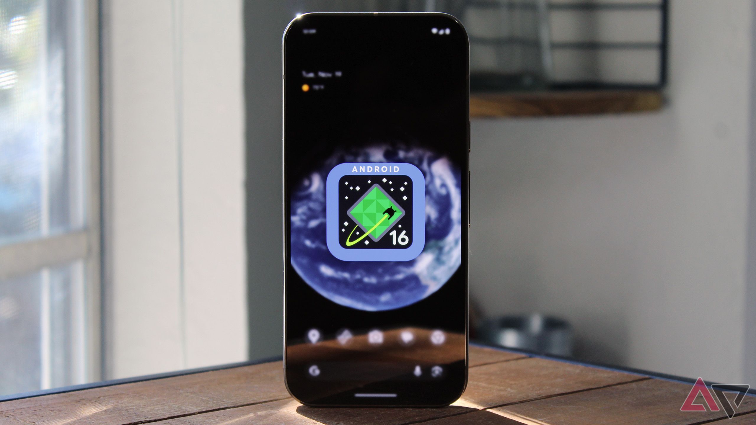 A phone with Android 16's logo on the display.