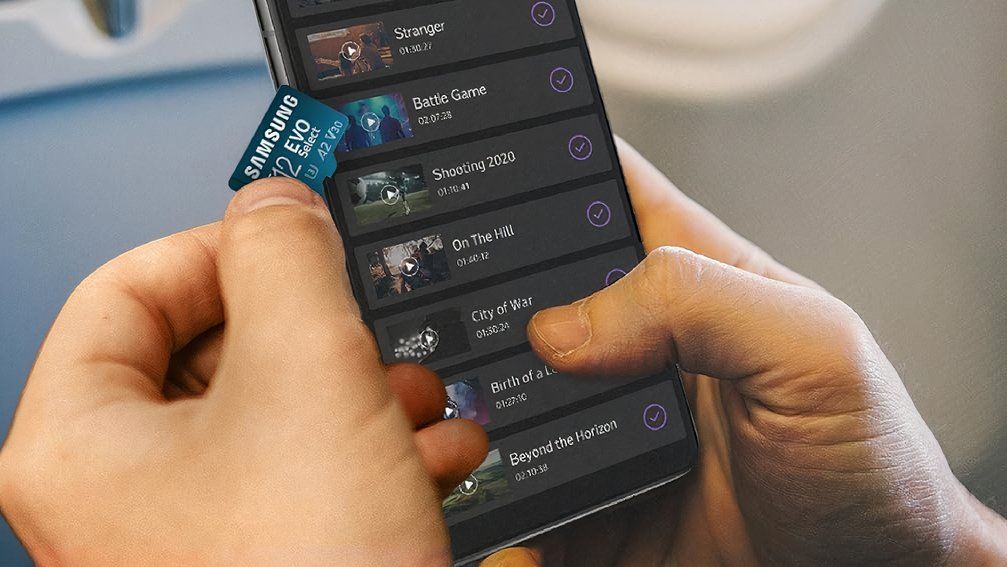 samsung evo select microsd lifestyle shot showing card in hand with phone