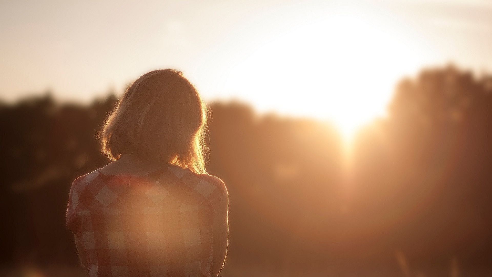 A woman relaxing while sitting in the sunset