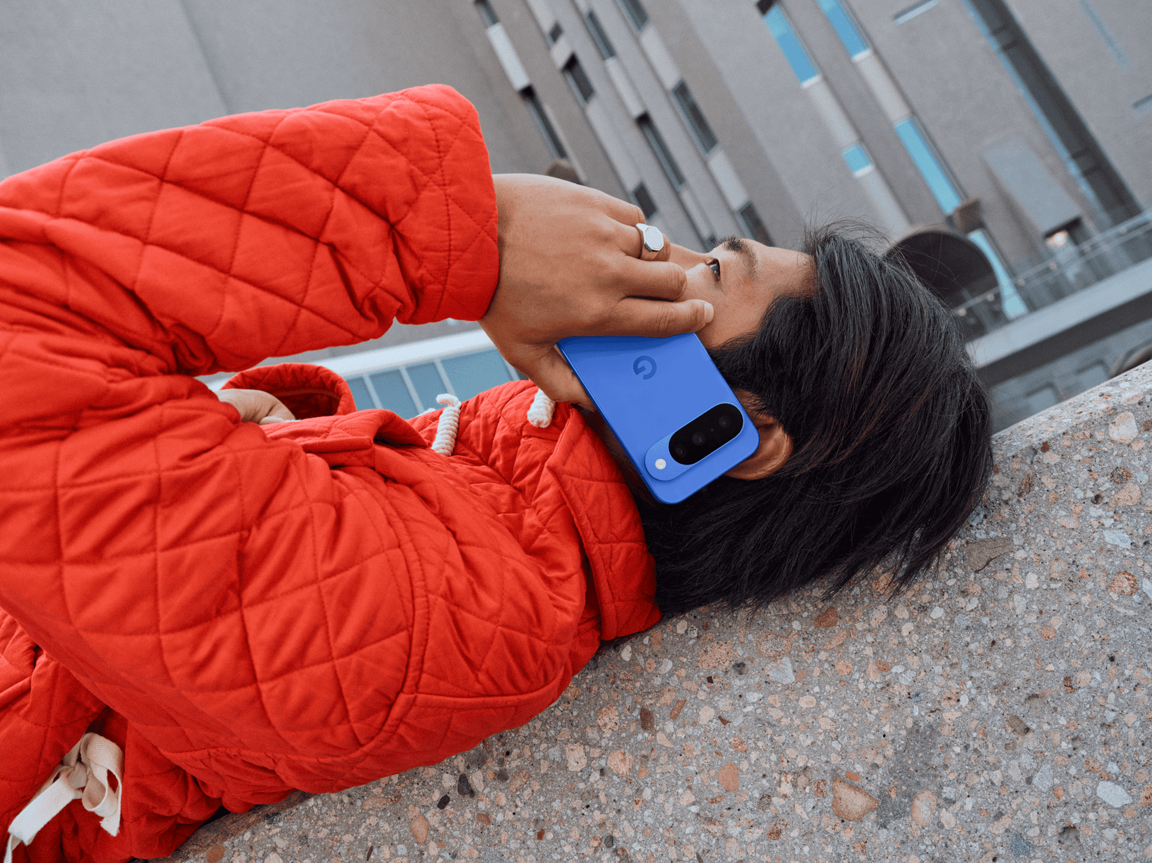 A person on the ground making an emergency call on a Google Pixel 10