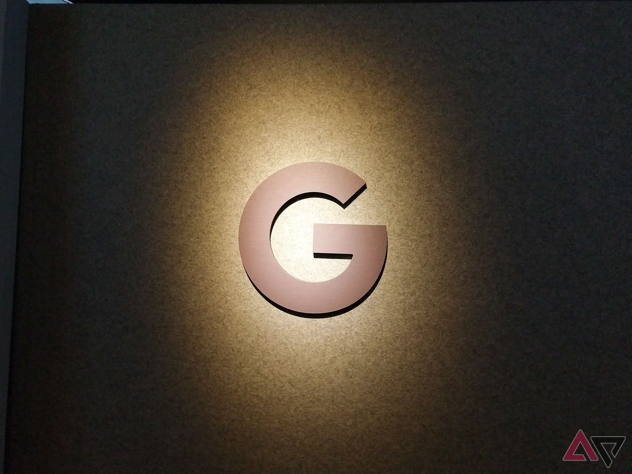 The Google lettermark under a spotlight