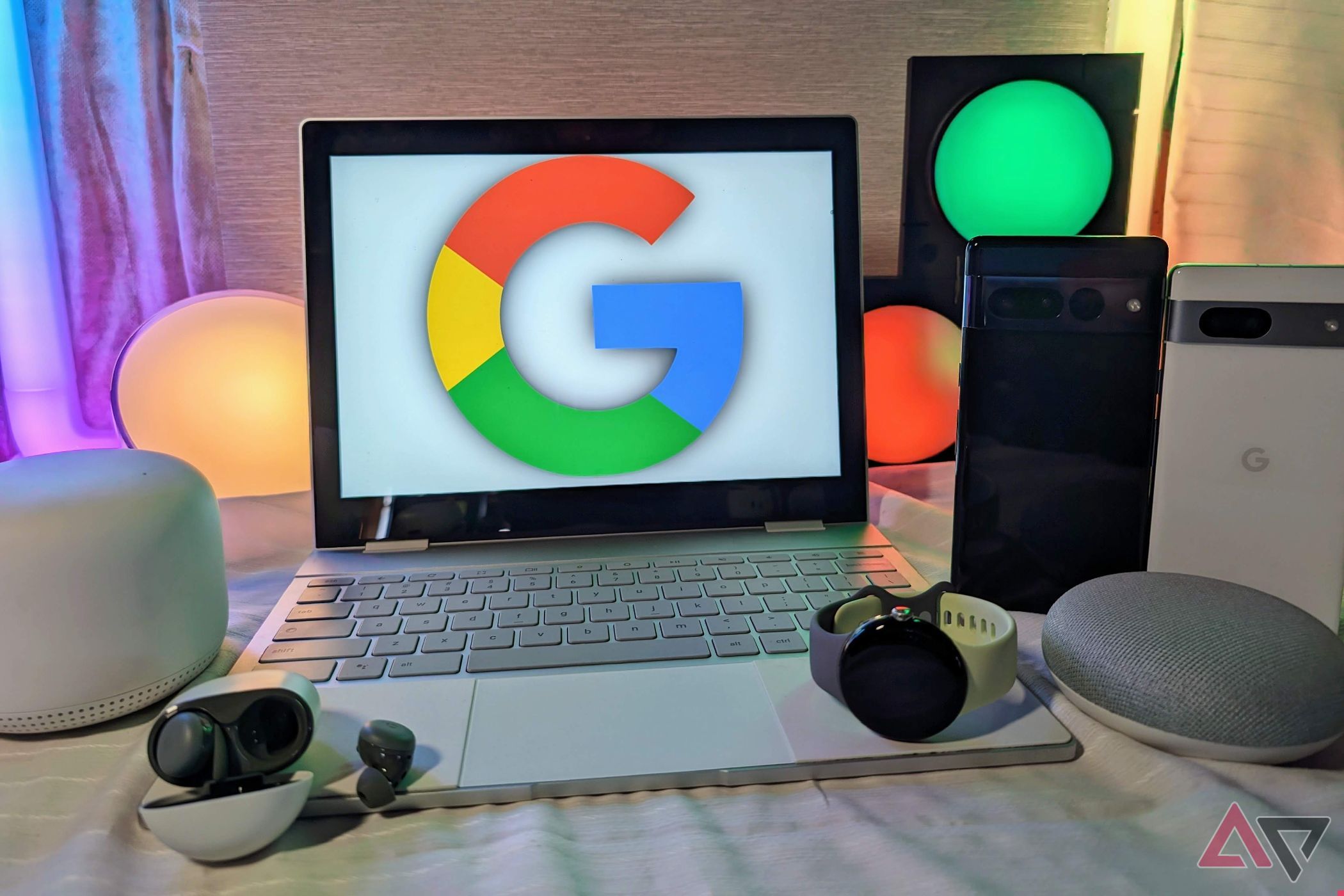 Google Pixel 7 Pro, Pixel Watch, Pixelbook, Nest Mini, and Pixel 7a together on a table