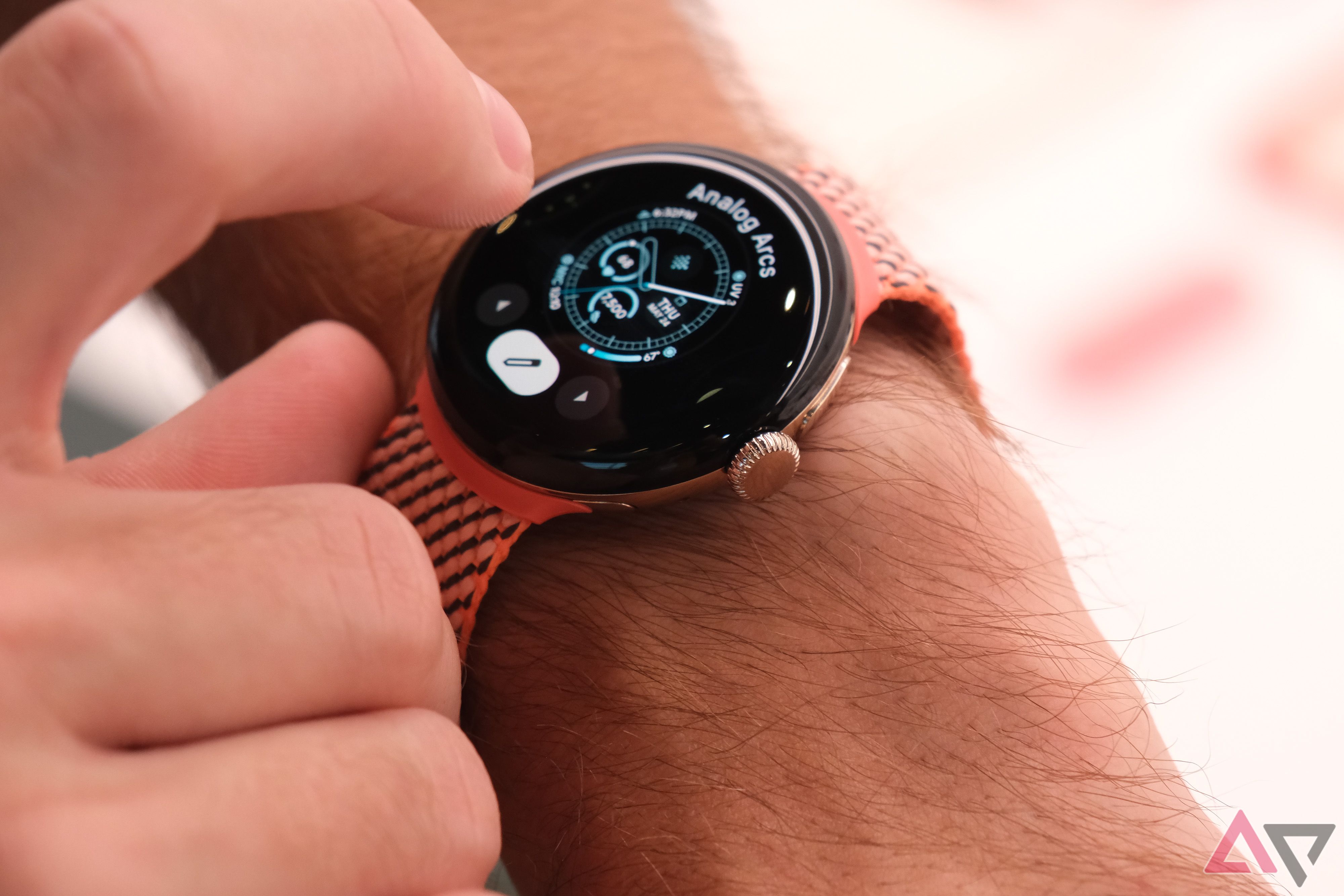 The Google Pixel Watch 2 displaying an analog watch face