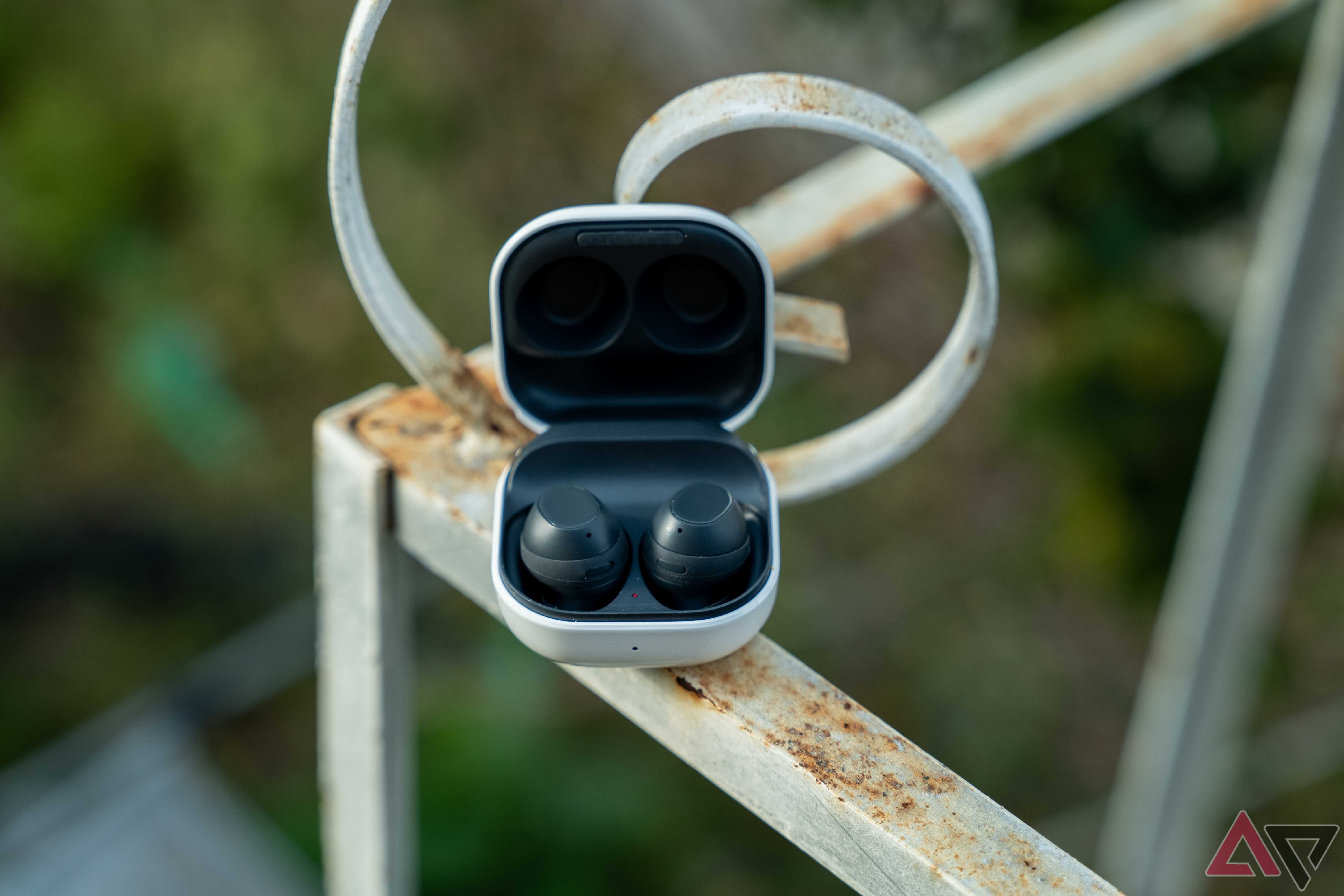 The Galaxy Buds FE case open on a rail