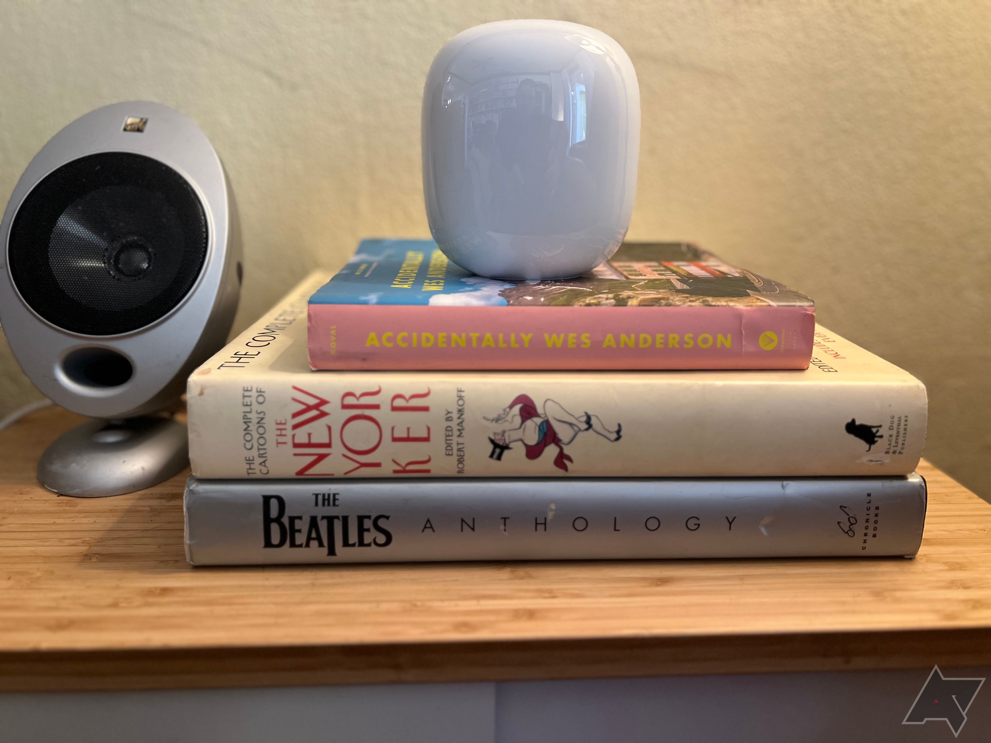 Google Nest Wifi Pro on a stack of books on a side table