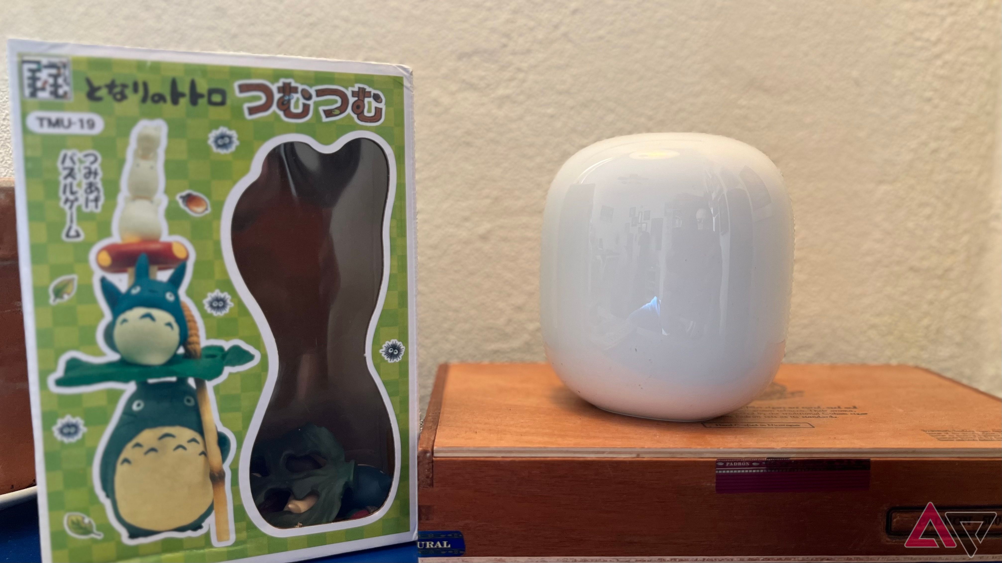 Google Nest Wifi Pro on cedar box next to Totoro toy