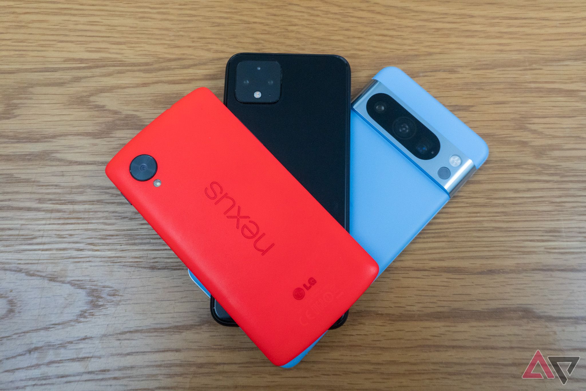The Google-Nexus 5 on top of a Pixel 4a and the Pixel 8 Pro