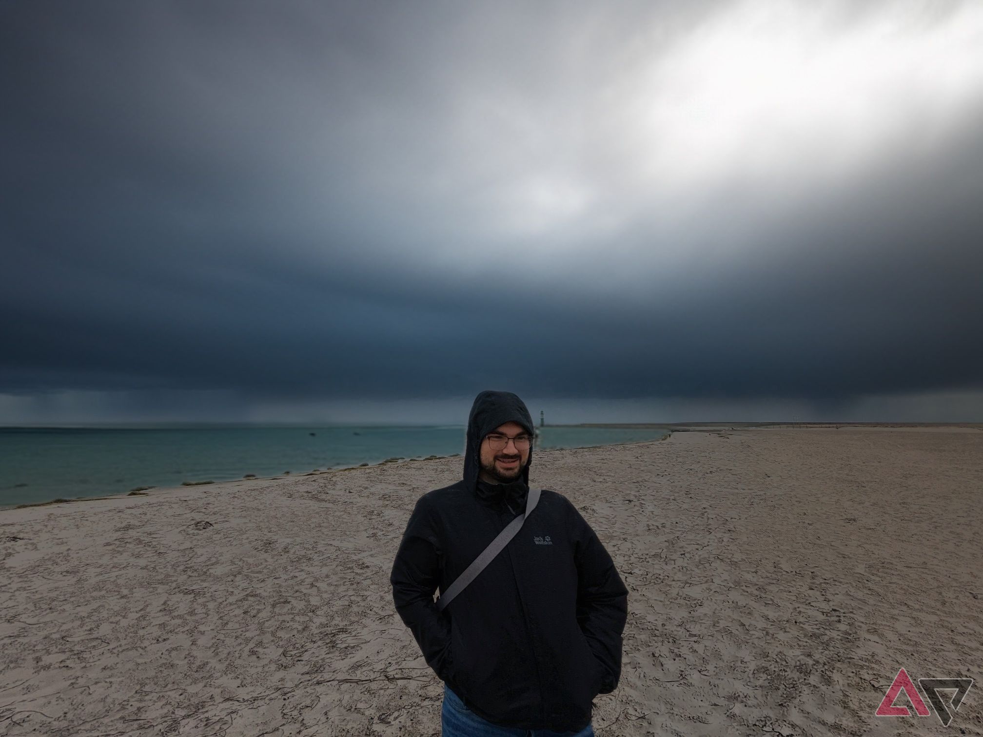 man standing in front of edited in storm clounds on beach